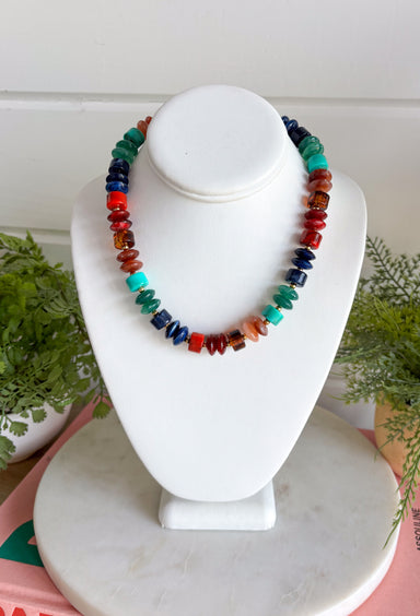 Turn up the color with this bold statement necklace from Treasure Jewels. An electric mix of turquoise, cobalt blue, emerald green, amber, and red beads creates a rich jewel-tone palette that instantly brings an outfit to life. A mix of bead shapes, sizes, and textures gives the necklace even more dimension and makes every color stand out. It’s the perfect piece for adding personality to a simple sweater, dress, or blouse when your outfit needs that one finishing touch.