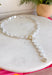 Classic pearls meet modern elegance in this stunning lariat necklace! Featuring lustrous pearls and a chic gold toggle closure, this timeless piece is finished with a sparkling rhinestone accent that adds just the right amount of shimmer. Whether you're dressing up for a holiday celebration, wedding, date night, or simply elevating your everyday style, this handcrafted necklace brings effortless sophistication to any outfit.