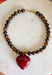 Rich natural tones and meaningful details make this handcrafted necklace a piece you'll treasure for years to come! Featuring genuine tiger eye natural stone beads, this beautiful necklace is finished with a striking burgundy heart pendant that adds the perfect pop of color. Whether worn alone or layered with your favorite chain, this timeless accessory effortlessly elevates everything from cozy sweaters to feminine dresses.