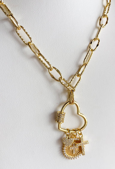 Meaningful, delicate, and full of sparkle! This 14k gold plated necklace features a beautiful mix of pavé crystal cross charms paired with a sweet mini heart charm that hangs from a gold open heart pendant. The combination of faith-inspired details and subtle shimmer creates a piece that feels both special and easy to wear. Set on a classic gold chain, this necklace layers beautifully with other favorites or stands out perfectly on its own. 