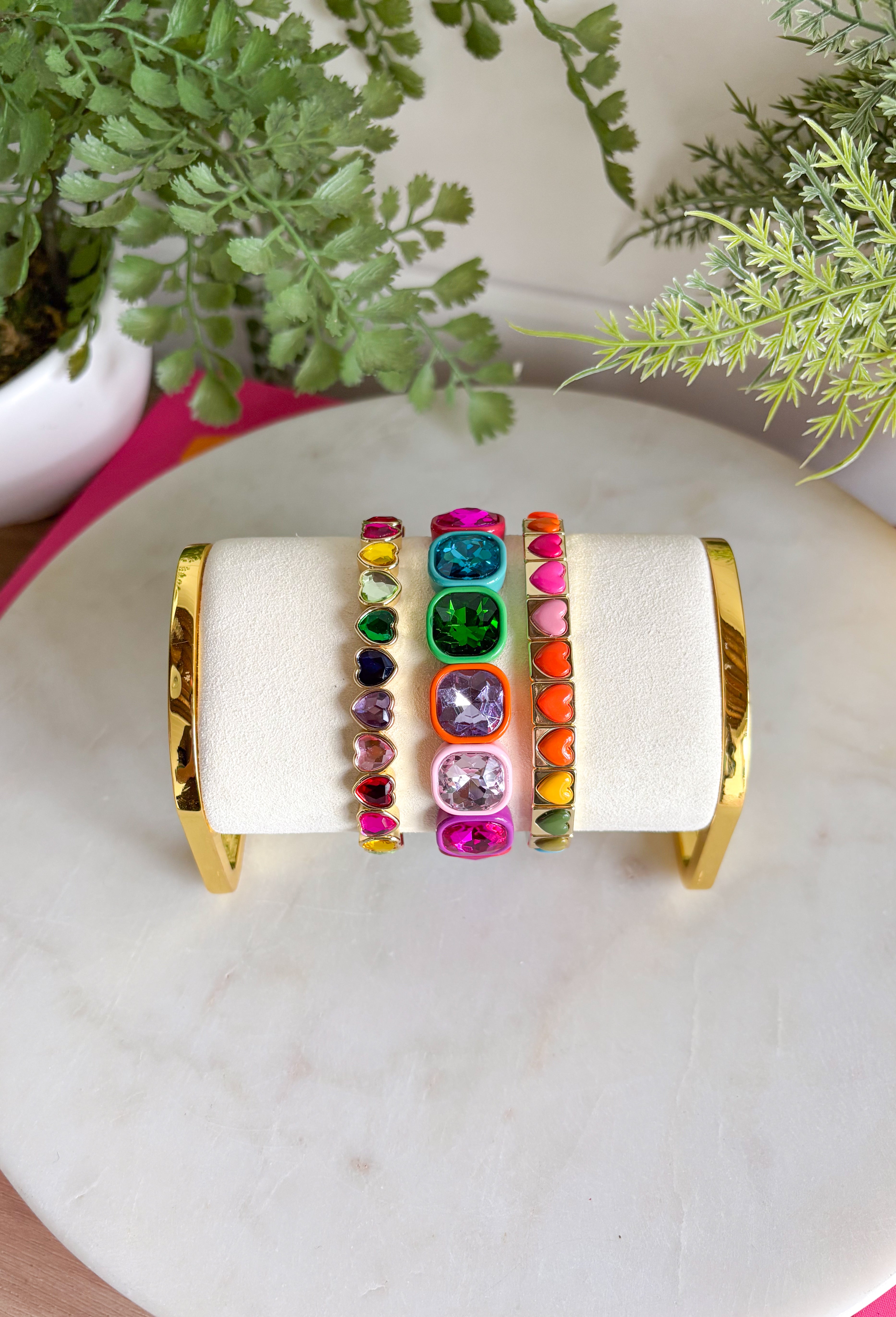 All the color, all the hearts, all the sparkle! This playful bracelet set is made to brighten your look with a vibrant mix of glossy heart tiles and oversized multi-color gemstone accents framed in warm gold tone settings. Each bracelet brings its own pop of color and shine, creating a fun, cheerful stack that instantly makes a statement.&nbsp;Designed to layer beautifully together, these bracelets create a bold, happy look when worn as a full stack. You can also mix and match them with your other favorites