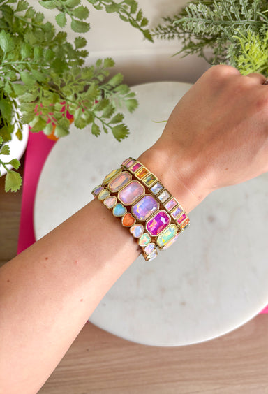 Soft sparkle with a romantic touch! This set of three bracelets features a beautiful mix of gold-tone bands, delicate crystal accents, and sweet pastel heart details for a look that feels feminine and timeless. Designed as stretch bracelets, they’re easy to slip on and comfortable for everyday wear. The gold-plated finish adds a polished shine, while the pastel tones bring a soft pop of color that’s perfect for layering. Wear all three together for a pretty stacked look or mix them with your favorite pieces