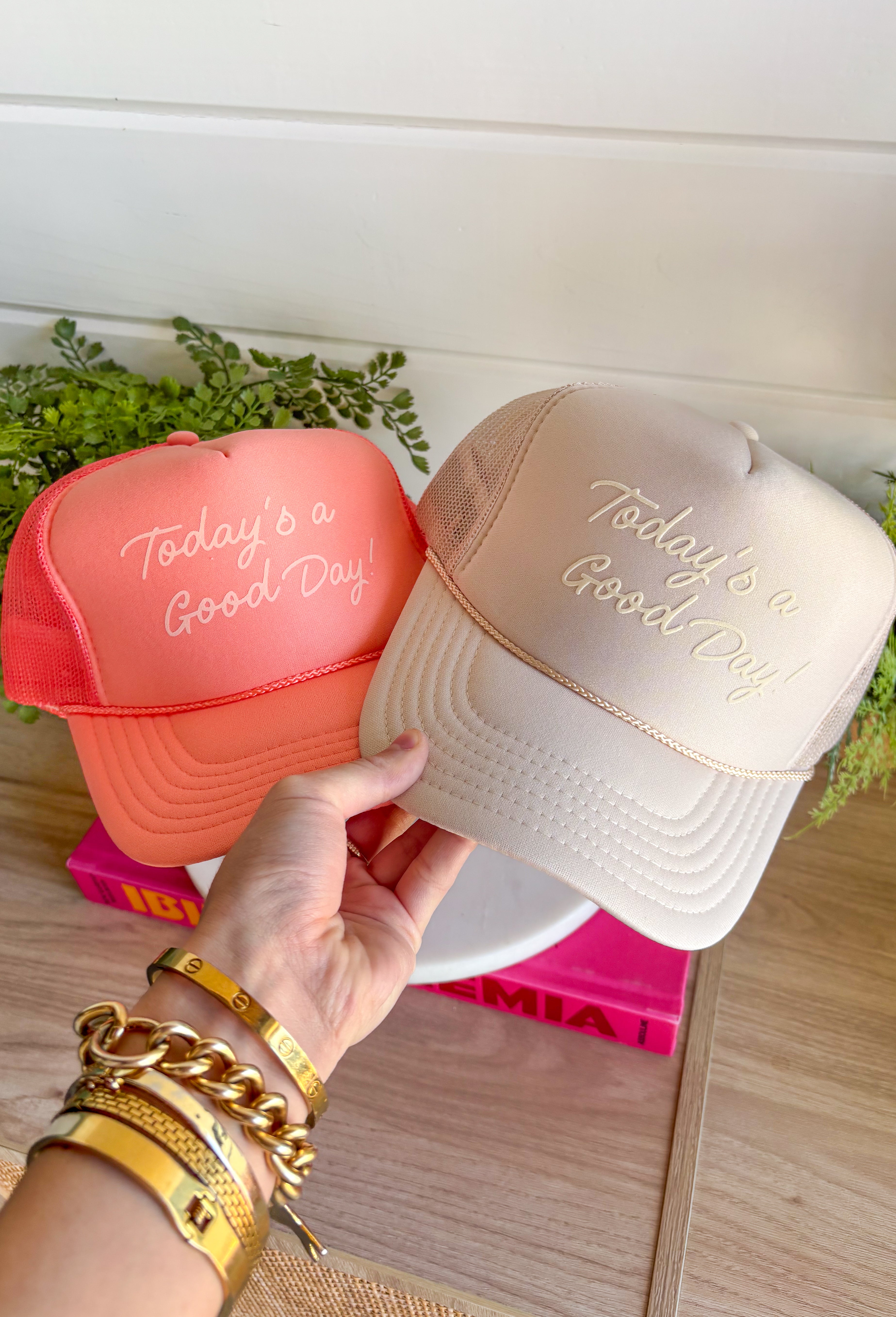 This tan trucker hat is your new go-to reminder to keep things light and positive! With its monochromatic “Today’s A Good Day” design, it’s simple, uplifting, and easy to style with all your summer outfits. The breathable mesh back keeps it cool for those hot, on-the-go days, while the adjustable fit makes it comfortable for all-day wear. Whether you're heading out for errands, a walk, or just enjoying some sunshine, this hat adds the perfect feel-good touch. Go ahead—throw it on and make it a good day!