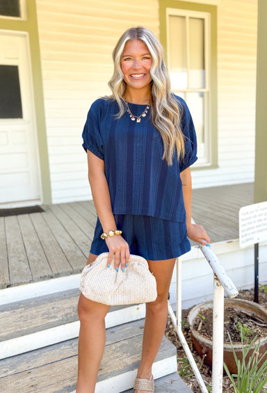 Back To Summer Set, navy short sleeve and short set, light blue thin line embroidery in vertical stripes down the top and shorts, sleeves on the top have elastic in the hem, shorts have pockets