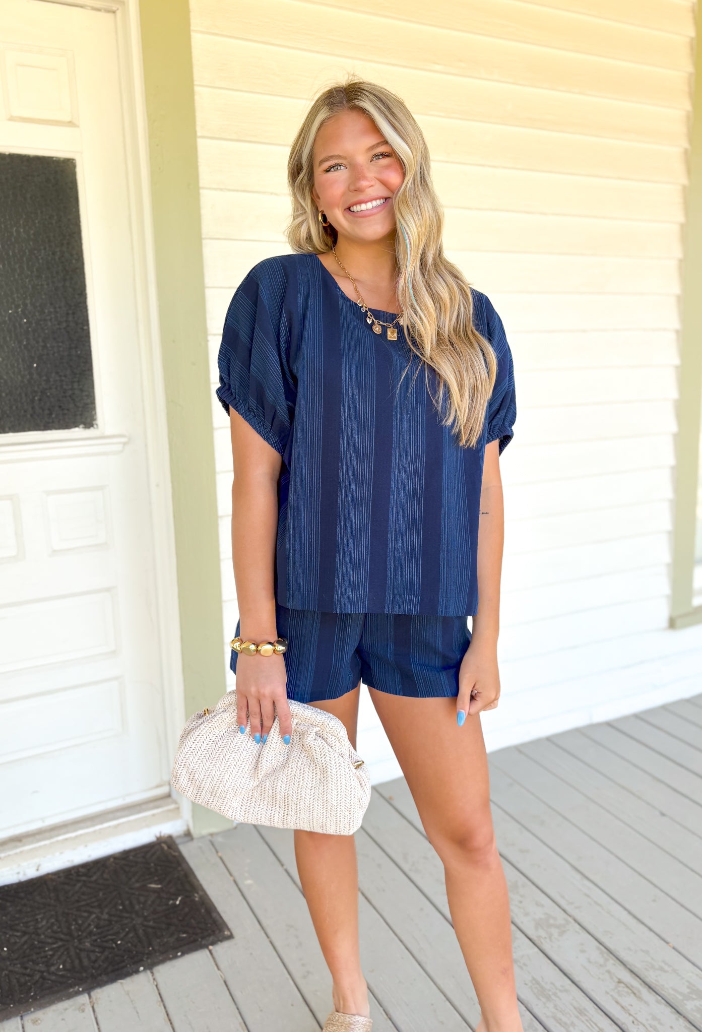 Back To Summer Set, navy short sleeve and short set, light blue thin line embroidery in vertical stripes down the top and shorts, sleeves on the top have elastic in the hem, shorts have pockets