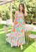 Dreamy Escape Maxi Dress, spaghetti strap maxi dress with tropical floral print and one tier on the bottom of the dress, print is in the colors green, seafoam, hot pink, bubblegum pink, yellow, orange, cobalt blue, magenta, and white