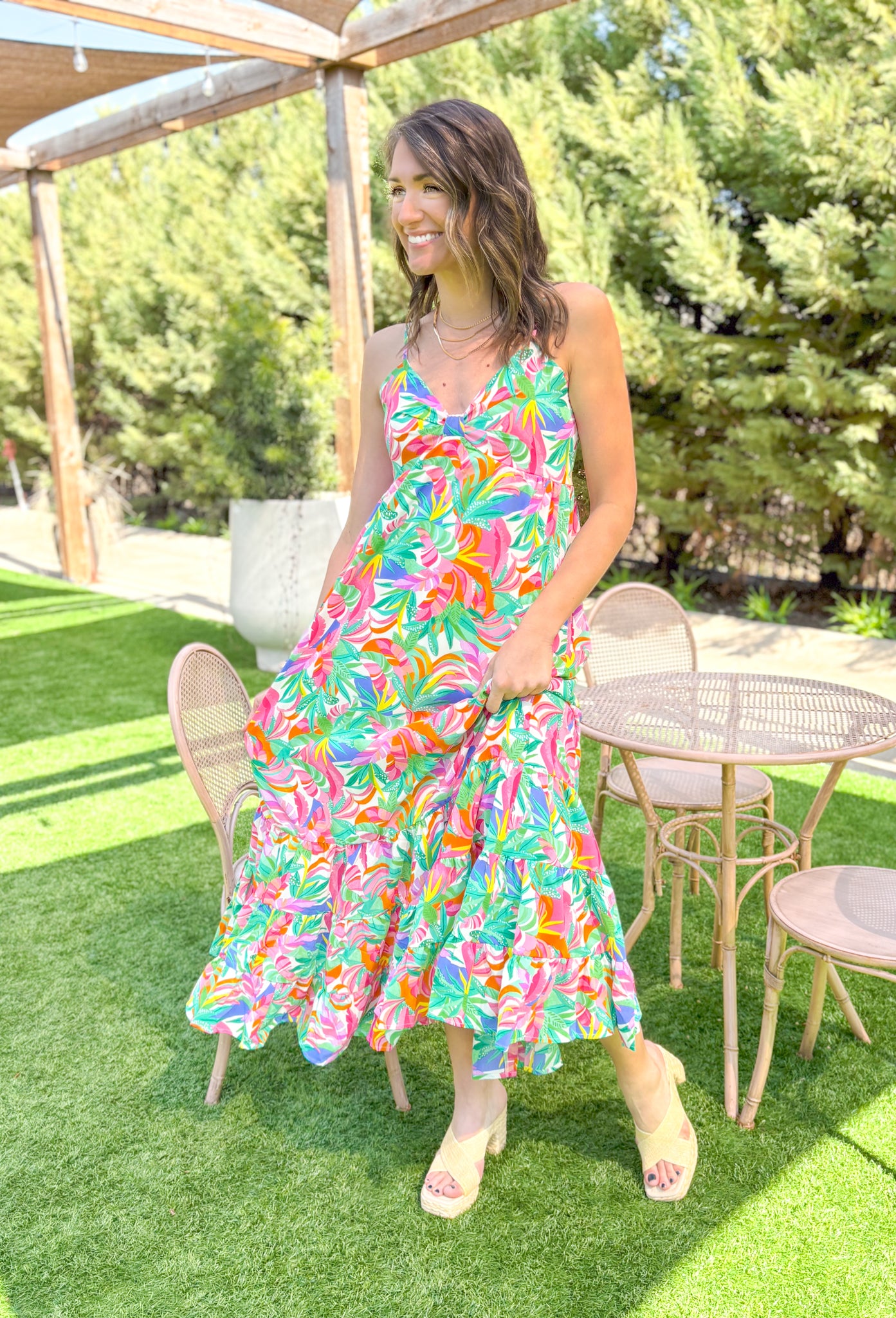 Dreamy Escape Maxi Dress, spaghetti strap maxi dress with tropical floral print and one tier on the bottom of the dress, print is in the colors green, seafoam, hot pink, bubblegum pink, yellow, orange, cobalt blue, magenta, and white