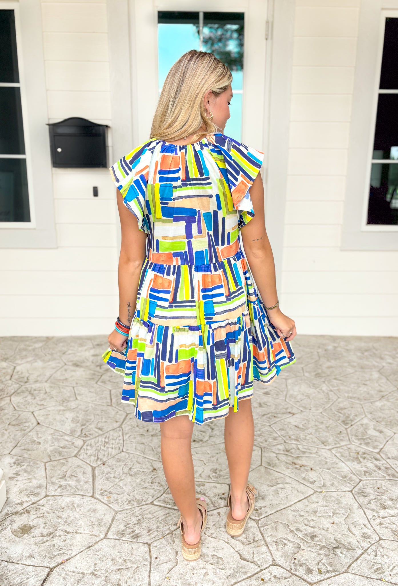 Just A Theory Dress, ruffle sleeve v-neck dress with tiering and abstract rectangles and squares in the colors dark blue, cobalt blue, white, orange, cream, lime green, and neon yellow