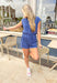 Late Summer Nights Romper, soft rayon polyester blend short sleeve romper with buttons down to the waist, elastic waist with drawstring, front pocket, rolled sleeve, collar, and pockets in a denim navy color 