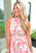 Sending Love Notes Floral Dress, pink, orange, red, yellow and off white sleeveless high-neck floral button down dress with white lace texture, white lace trimming on the arm holes and around the neck as well as a matching belt