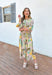 Set Me Free Midi Dress, quarter sleeve button down midi dress in a pale salmon color with sage green, amazon green and mustard yellow palm leaves printed across the dress, matching tie belt around the waist