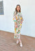 Set Me Free Midi Dress, quarter sleeve button down midi dress in a pale salmon color with sage green, amazon green and mustard yellow palm leaves printed across the dress, matching tie belt around the waist