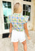 Somewhere Sunny Blouse, ruffle sleeve v-neck blouse with ruffling around the neck, patterned blouse in the colors blue, green, yellow, red and white 
