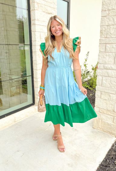 Summer Evening Breeze Midi Dress, tiered ruffle sleeve midi dress with cinching around the waist, tan trim on the ruffle sleeve and v-neck line, kelly green bottom tier and ruffle sleeve, baby blue middle section 