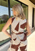 Bring effortless sophistication to your everyday wardrobe with this beautifully detailed top from Entro. Designed in a rich chocolate brown and cream stripe print, this sleeveless top offers a timeless look that's easy to dress up or down. The flattering square neckline creates a polished silhouette, while the side tie detail adds a feminine touch and subtle shape. Pair it with the matching pants for a coordinated set, or style it on its own with your favorite denim or trousers.