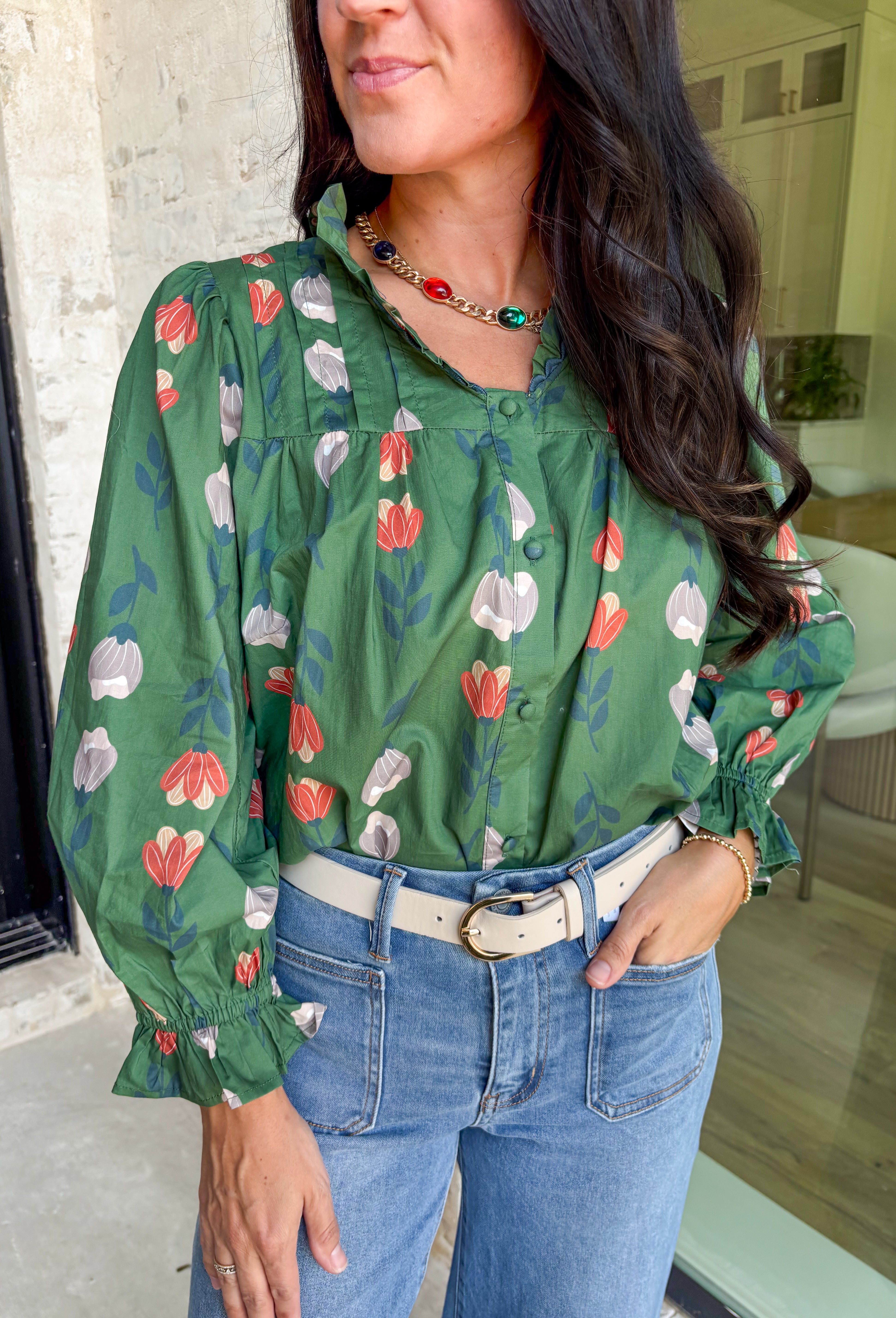 Romantic florals with delicate details—this green button-down top is a fall must-have. The all over floral print in shades of charcoal, rust, and cream feels warm and seasonal, while smocked sleeves and a ruffle neckline add a soft, feminine touch. Scalloped trim frames the neckline for a sweet finishing detail, making this lightweight cotton blouse an easy choice for workdays, weekends, or cozy outings.