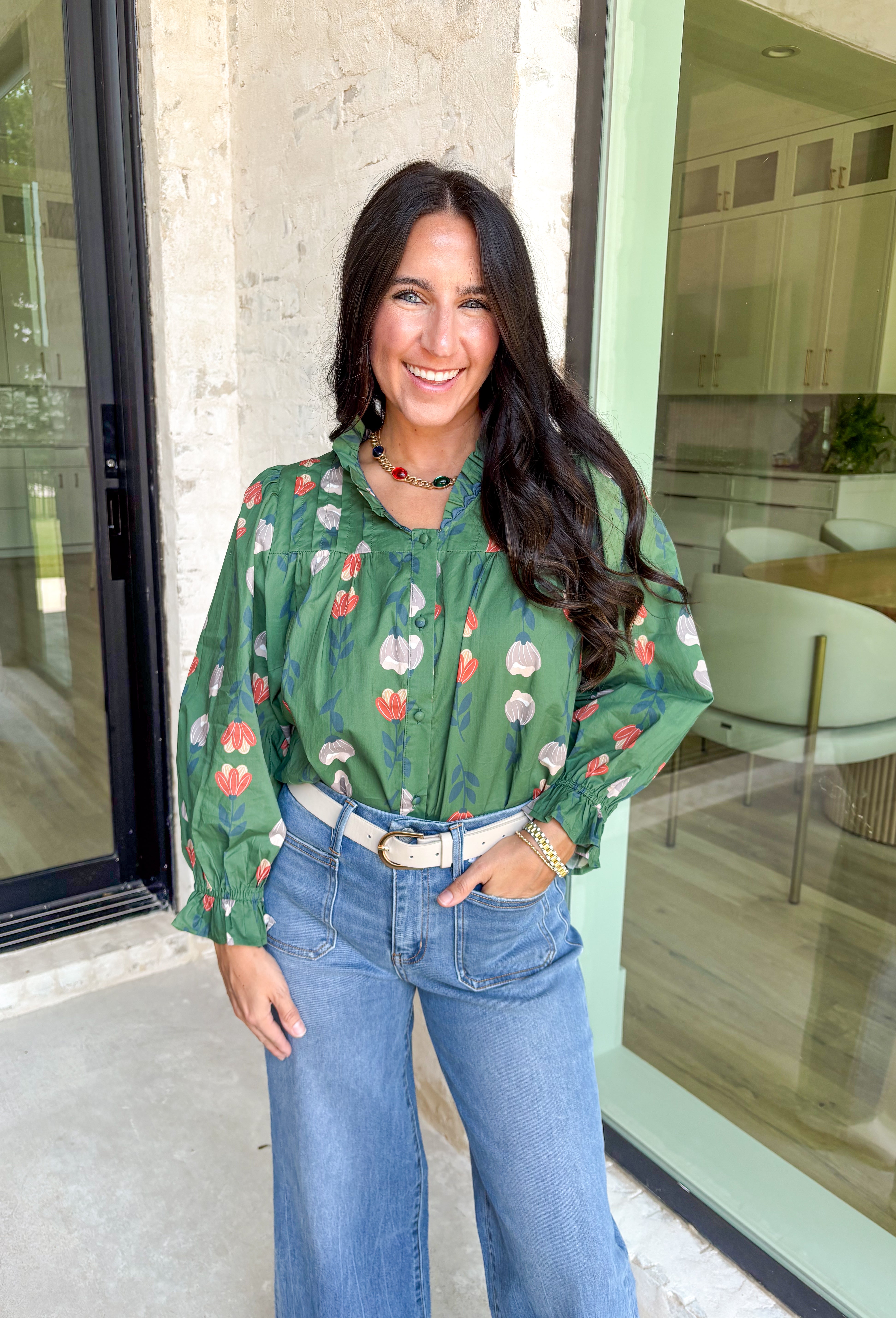 Romantic florals with delicate details—this green button-down top is a fall must-have. The all over floral print in shades of charcoal, rust, and cream feels warm and seasonal, while smocked sleeves and a ruffle neckline add a soft, feminine touch. Scalloped trim frames the neckline for a sweet finishing detail, making this lightweight cotton blouse an easy choice for workdays, weekends, or cozy outings.