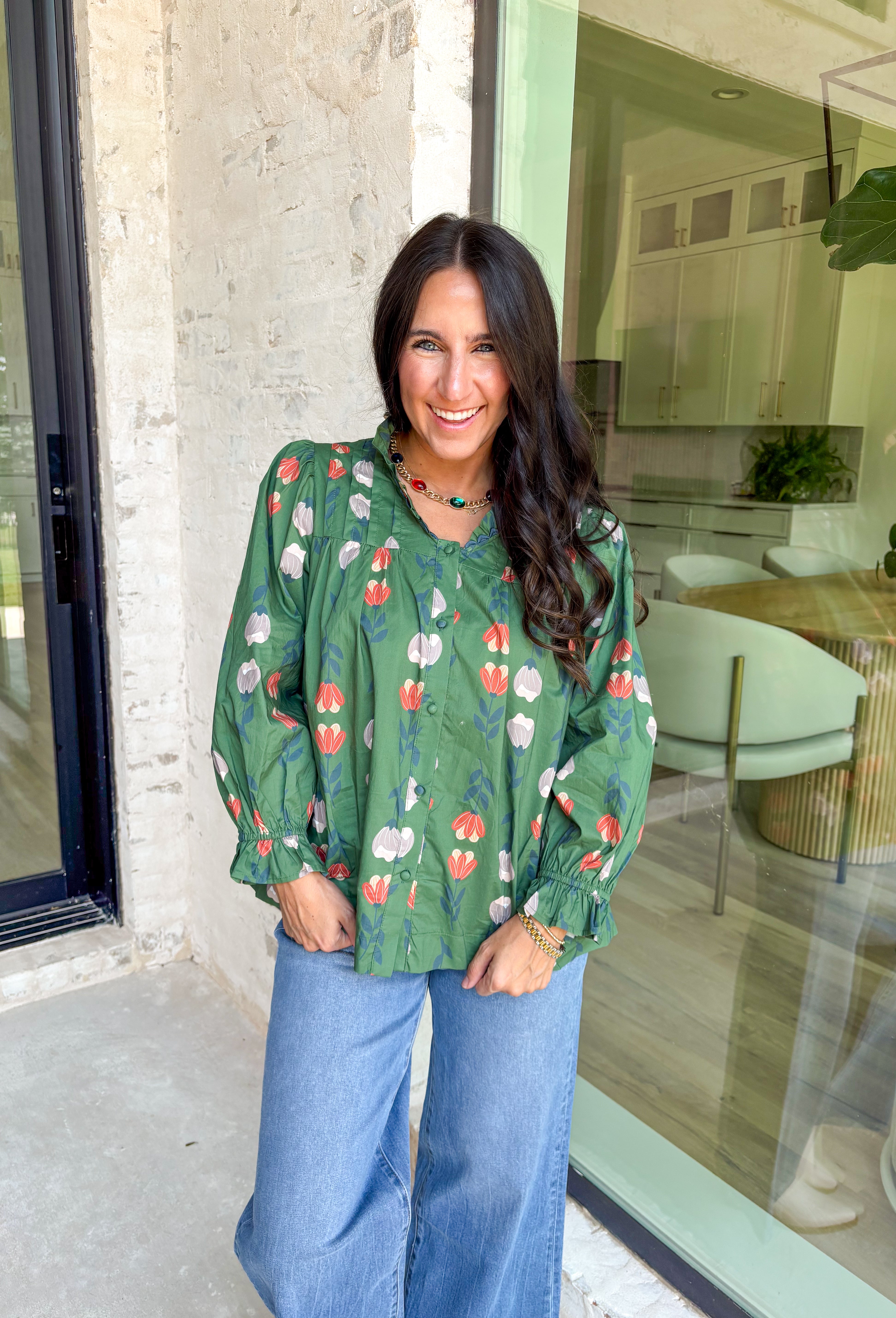 Romantic florals with delicate details—this green button-down top is a fall must-have. The all over floral print in shades of charcoal, rust, and cream feels warm and seasonal, while smocked sleeves and a ruffle neckline add a soft, feminine touch. Scalloped trim frames the neckline for a sweet finishing detail, making this lightweight cotton blouse an easy choice for workdays, weekends, or cozy outings.