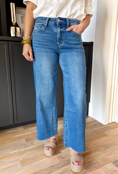 These medium wash high rise jeans offer a wide leg cut, creating a flattering silhouette that is both trendy and comfortable. Perfect for any occasion, these jeans are a must-have!