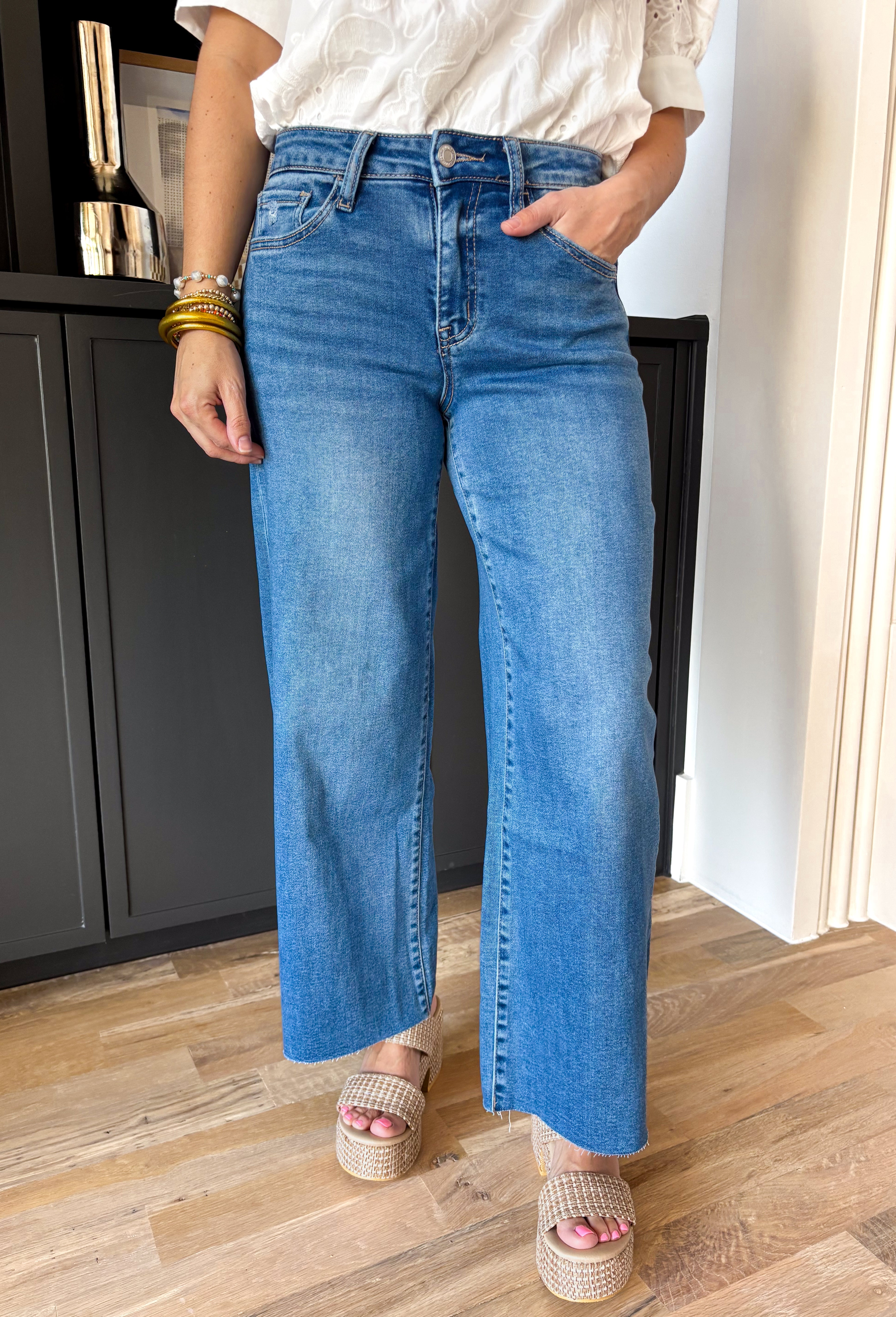 These medium wash high rise jeans offer a wide leg cut, creating a flattering silhouette that is both trendy and comfortable. Perfect for any occasion, these jeans are a must-have!