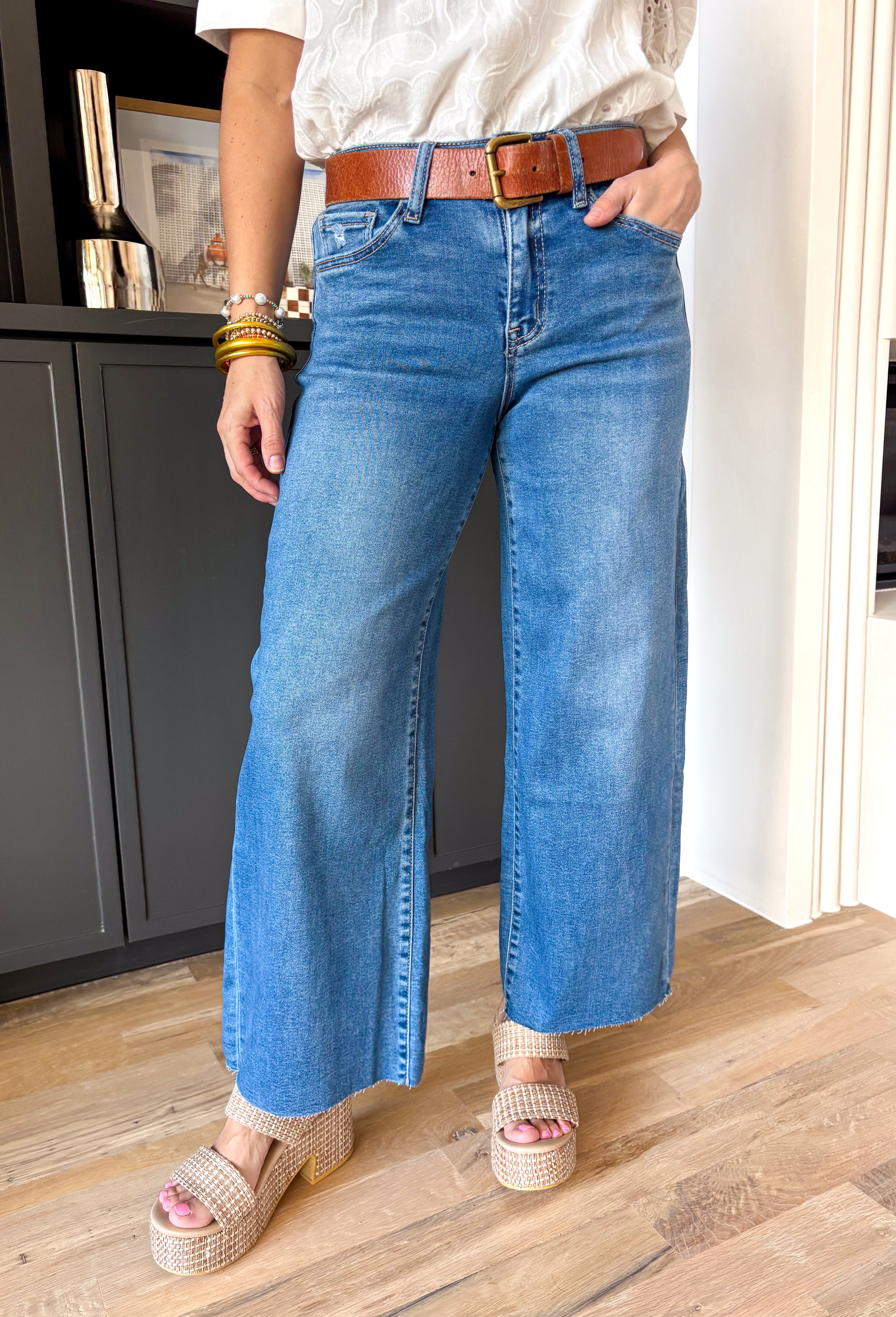 These medium wash high rise jeans offer a wide leg cut, creating a flattering silhouette that is both trendy and comfortable. Perfect for any occasion, these jeans are a must-have!
