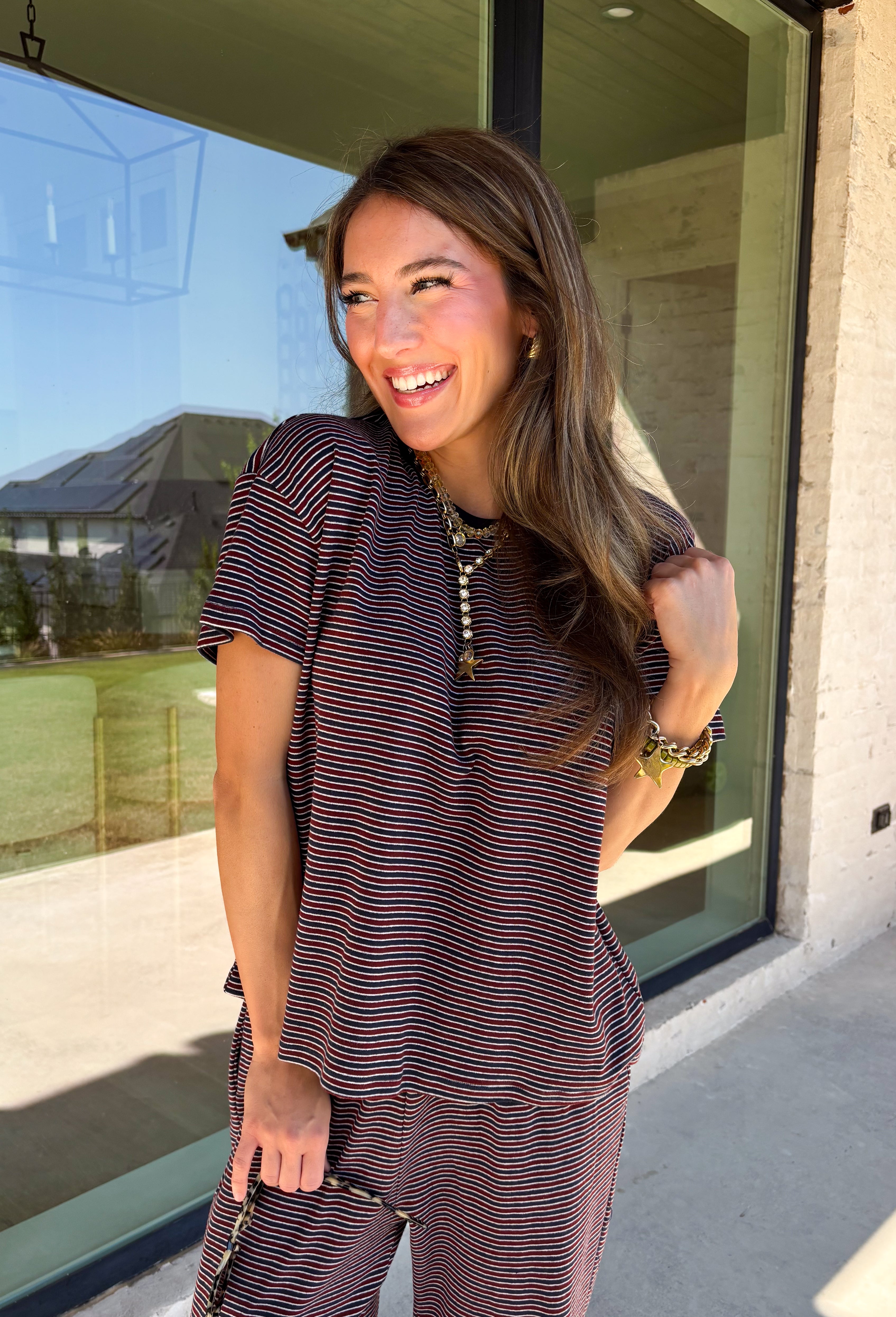 Easy days call for a matching set that looks put together without sacrificing comfort. This two-piece set from Twentifourth features a short sleeve tee and coordinating wide leg pants in a rich mix of merlot, navy, and off white stripes. The soft cotton-blend fabric has a touch of stretch for comfortable all-day wear, while the elastic waistband keeps the pants relaxed and easy. 