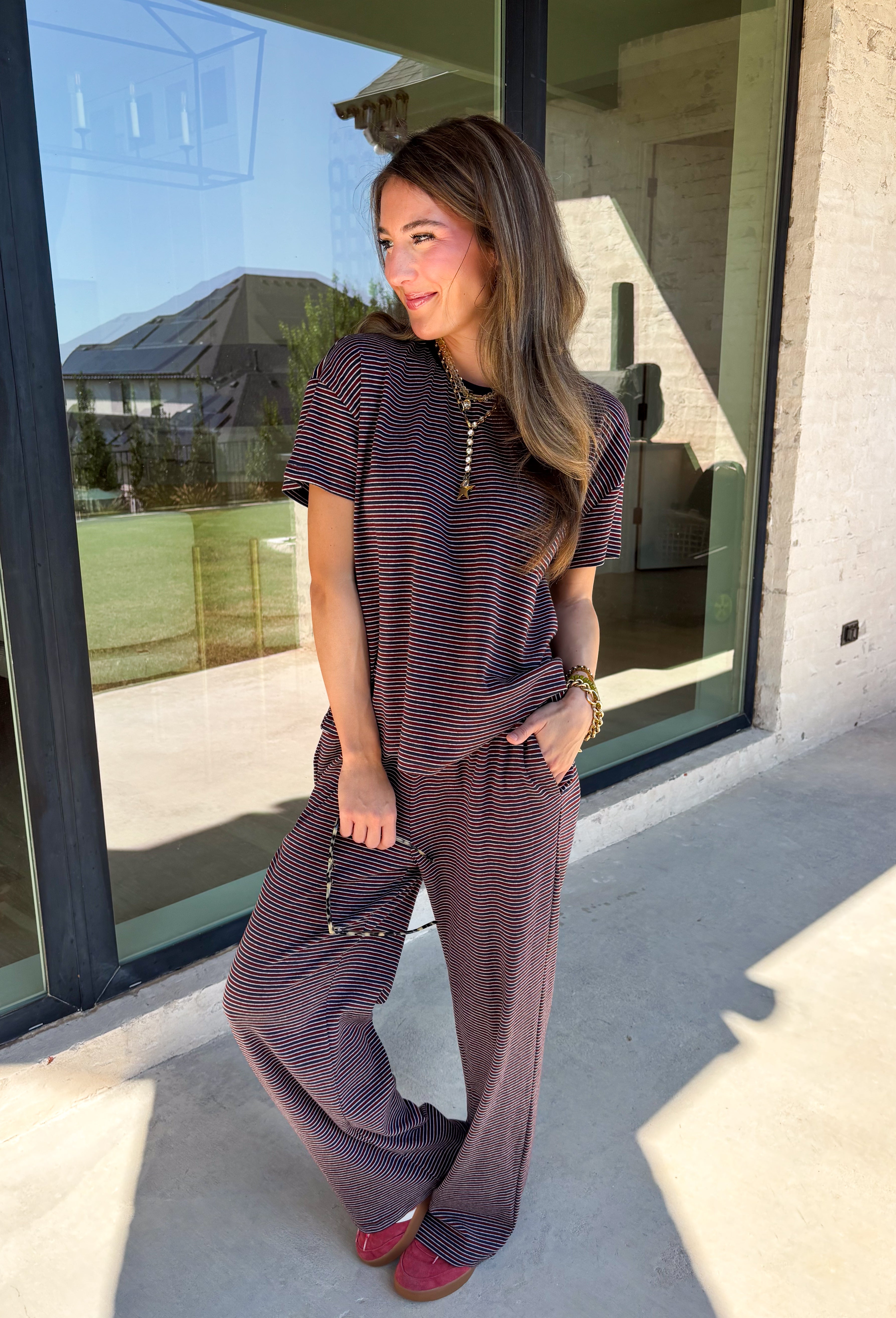 Easy days call for a matching set that looks put together without sacrificing comfort. This two-piece set from Twentifourth features a short sleeve tee and coordinating wide leg pants in a rich mix of merlot, navy, and off white stripes. The soft cotton-blend fabric has a touch of stretch for comfortable all-day wear, while the elastic waistband keeps the pants relaxed and easy. 