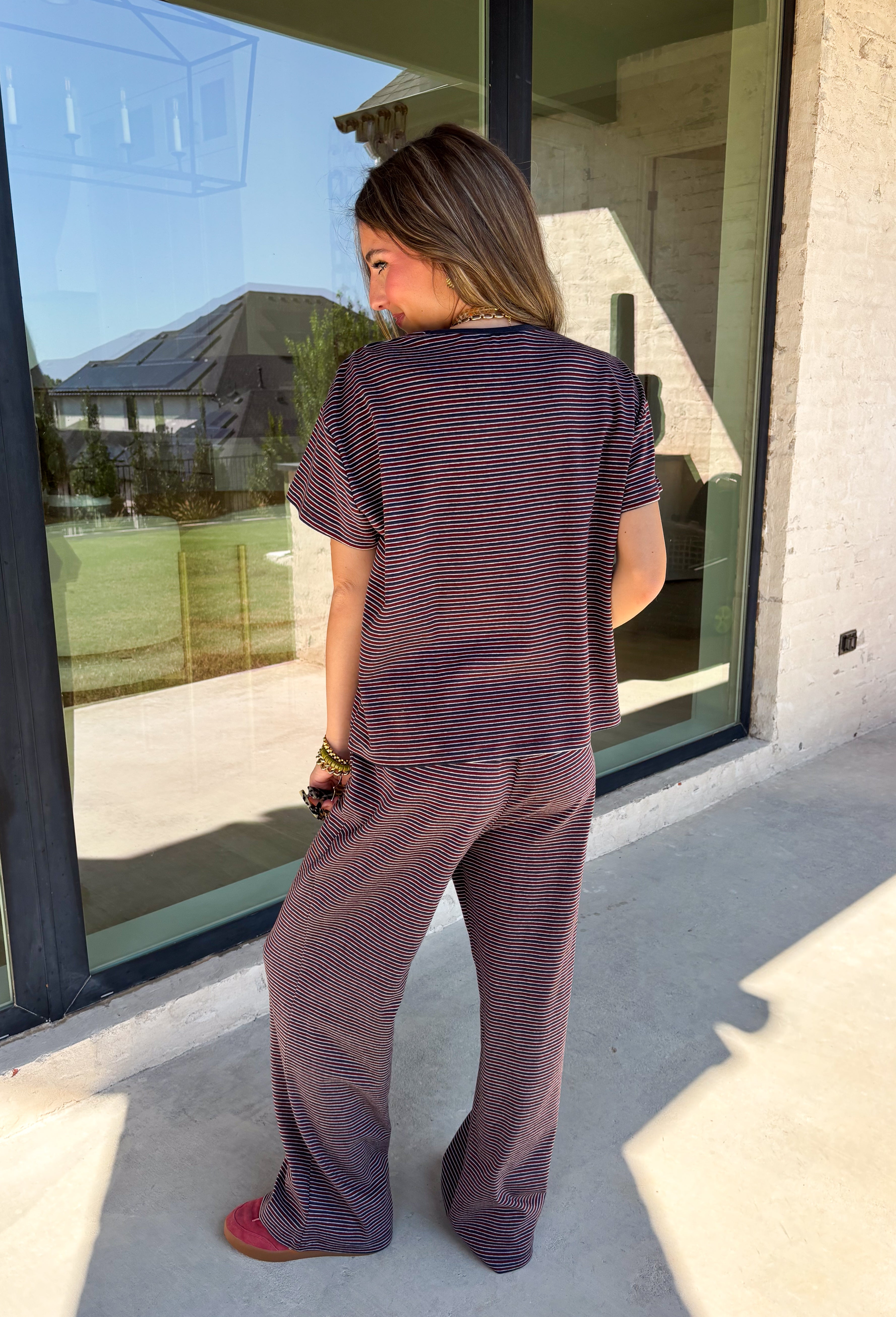 Easy days call for a matching set that looks put together without sacrificing comfort. This two-piece set from Twentifourth features a short sleeve tee and coordinating wide leg pants in a rich mix of merlot, navy, and off white stripes. The soft cotton-blend fabric has a touch of stretch for comfortable all-day wear, while the elastic waistband keeps the pants relaxed and easy. 