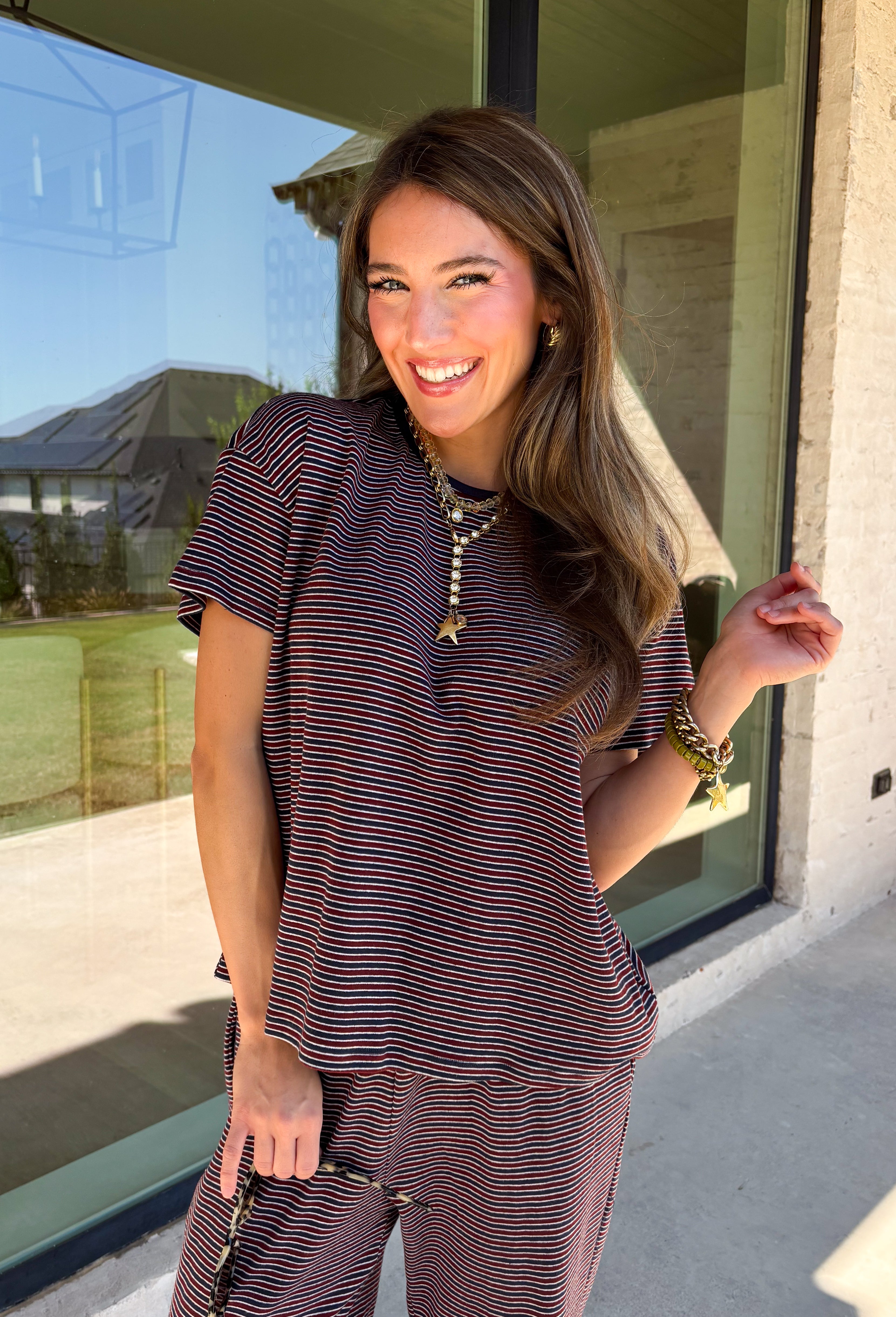 Easy days call for a matching set that looks put together without sacrificing comfort. This two-piece set from Twentifourth features a short sleeve tee and coordinating wide leg pants in a rich mix of merlot, navy, and off white stripes. The soft cotton-blend fabric has a touch of stretch for comfortable all-day wear, while the elastic waistband keeps the pants relaxed and easy. 