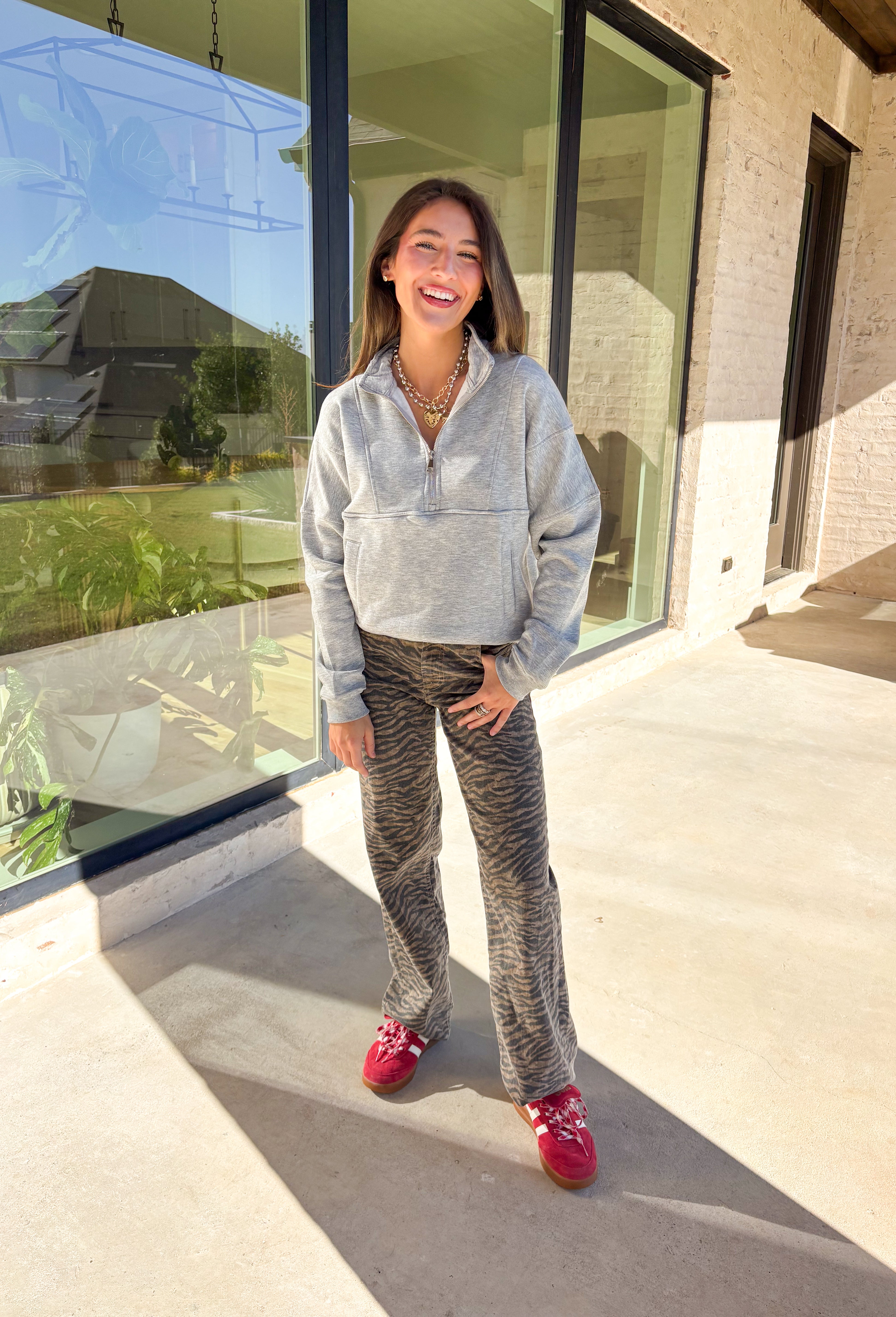 Stay warm and stylish in this heather grey quarter zip pullover by Iris. Designed with a soft fleece lining, it’s as cozy as it looks. The quarter zip neckline adds versatility, while the two front pockets make it practical for everyday wear. With just the right amount of stretch in the fabric, this pullover is perfect for lounging, layering, or running errands in comfort.&nbsp;