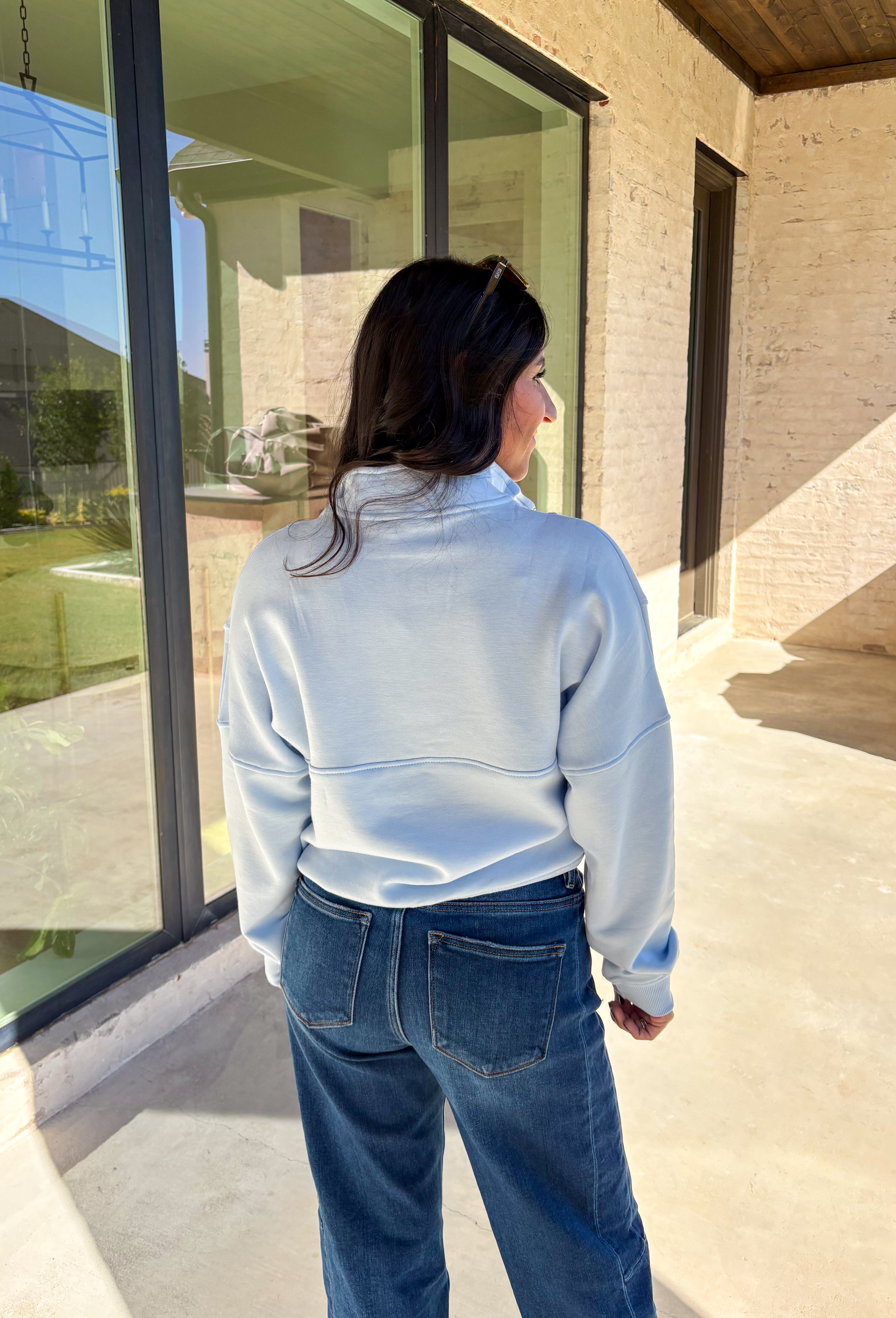 Stay warm and stylish in this light blue quarter zip pullover by Iris. Designed with a soft fleece lining, it’s as cozy as it looks. The quarter zip neckline adds versatility, while the two front pockets make it practical for everyday wear. With just the right amount of stretch in the fabric, this pullover is perfect for lounging, layering, or running errands in comfort.&nbsp;