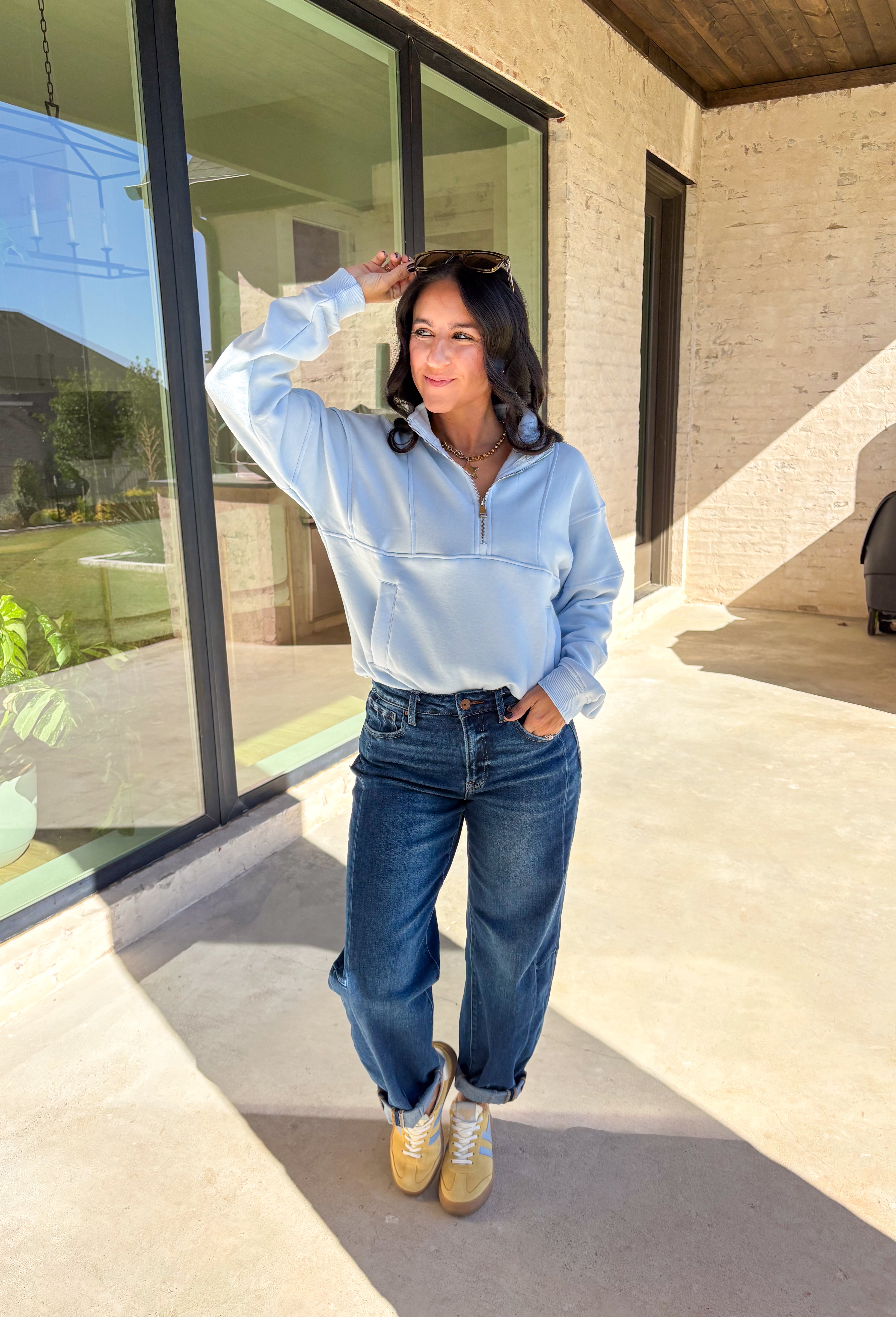 Stay warm and stylish in this light blue quarter zip pullover by Iris. Designed with a soft fleece lining, it’s as cozy as it looks. The quarter zip neckline adds versatility, while the two front pockets make it practical for everyday wear. With just the right amount of stretch in the fabric, this pullover is perfect for lounging, layering, or running errands in comfort.&nbsp;