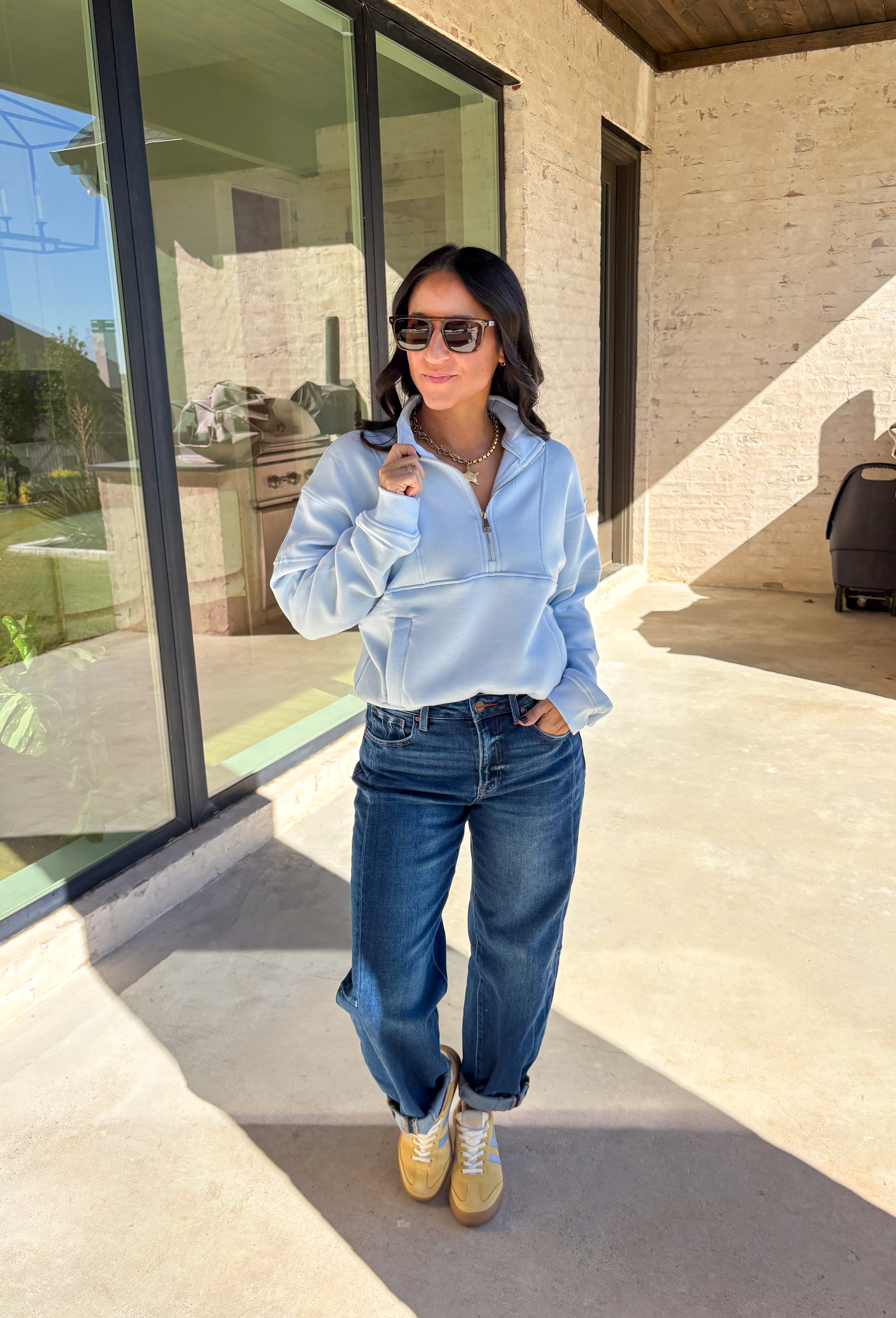 Stay warm and stylish in this light blue quarter zip pullover by Iris. Designed with a soft fleece lining, it’s as cozy as it looks. The quarter zip neckline adds versatility, while the two front pockets make it practical for everyday wear. With just the right amount of stretch in the fabric, this pullover is perfect for lounging, layering, or running errands in comfort.&nbsp;