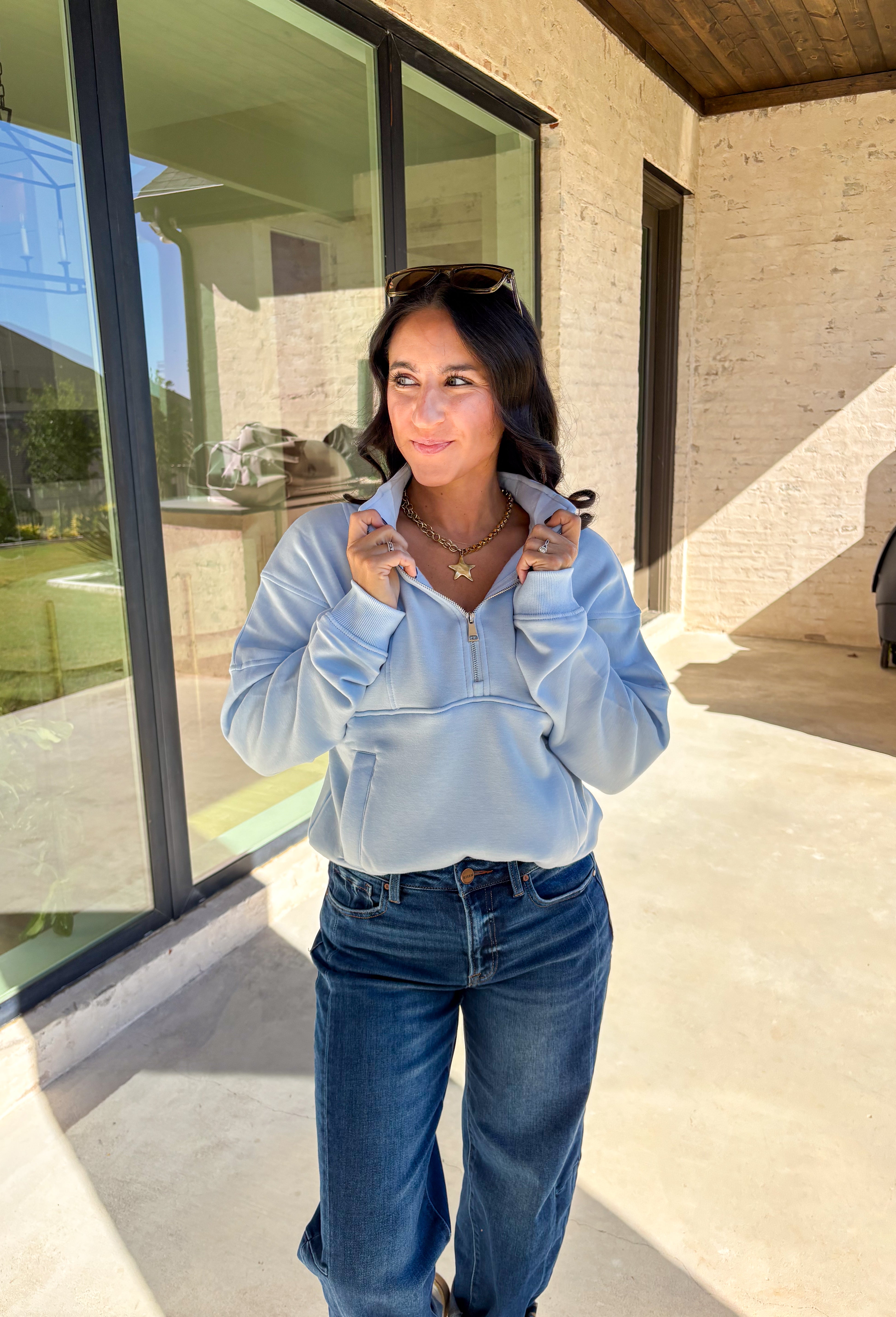 Stay warm and stylish in this light blue quarter zip pullover by Iris. Designed with a soft fleece lining, it’s as cozy as it looks. The quarter zip neckline adds versatility, while the two front pockets make it practical for everyday wear. With just the right amount of stretch in the fabric, this pullover is perfect for lounging, layering, or running errands in comfort.&nbsp;