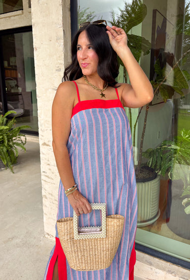 This chambray midi dress is made for all your 4th of July celebrations! From backyard BBQs and parades to fireworks under the stars, this dress is the perfect patriotic pick. The red and white stripe print pops against the chambray blue background, while the bold red contrast trim adds a fun, festive touch. Adjustable straps and a smocked back create a comfortable, flattering fit, and the side slits add easy movement for warm summer days. Fully lined and finished with side pockets.