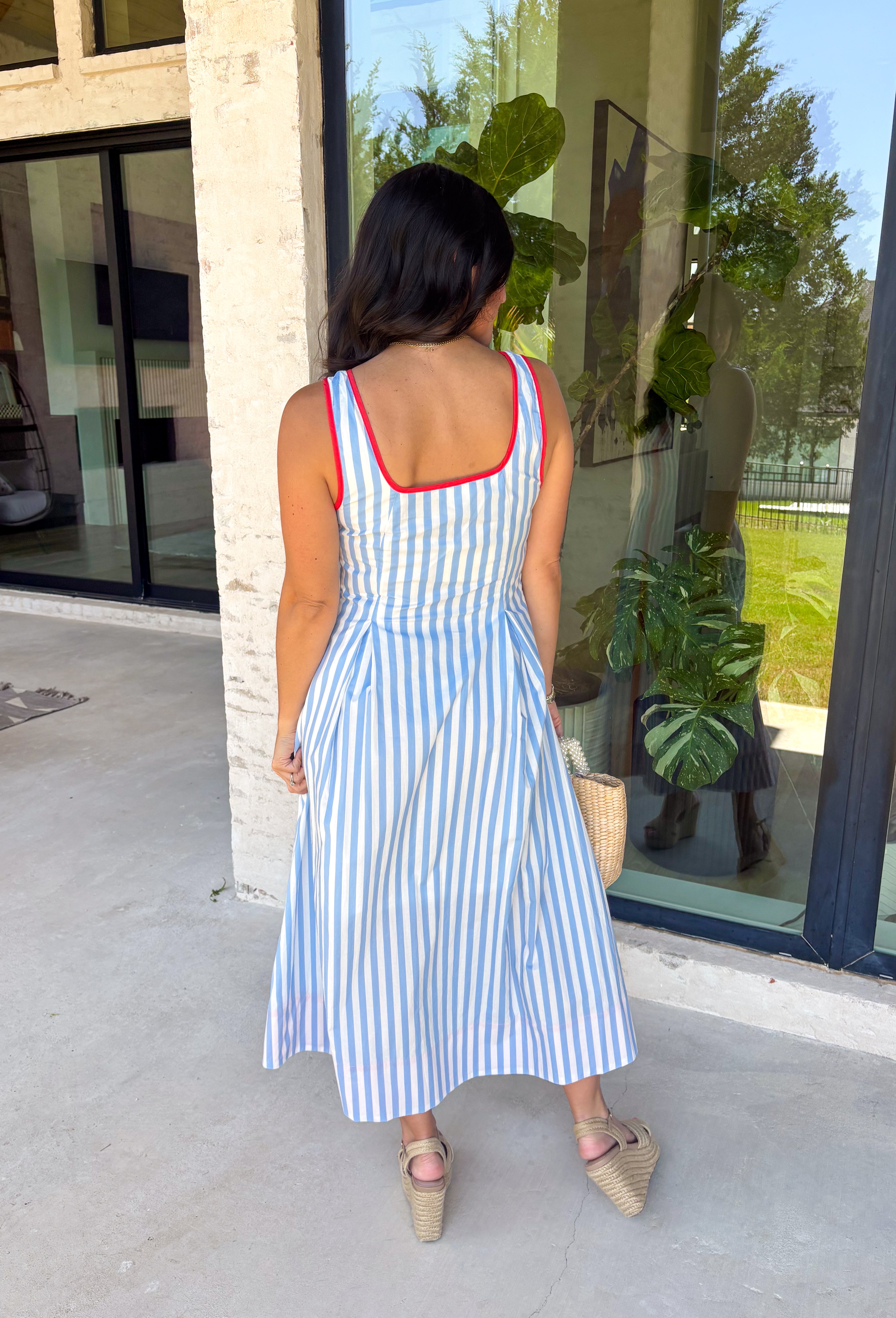 Classic stripes with a pop of color? Yes please! This blue and white striped sleeveless midi dress by Entro is the perfect spring-to-summer piece when you want something easy, flattering, and a little fun. The red contrast trim adds the cutest standout detail, and the v-cut neckline gives it a clean, modern touch that feels effortlessly polished. Just add sandals and sunnies for daytime, or dress it up with wedges and gold jewelry for an easy night-out look.