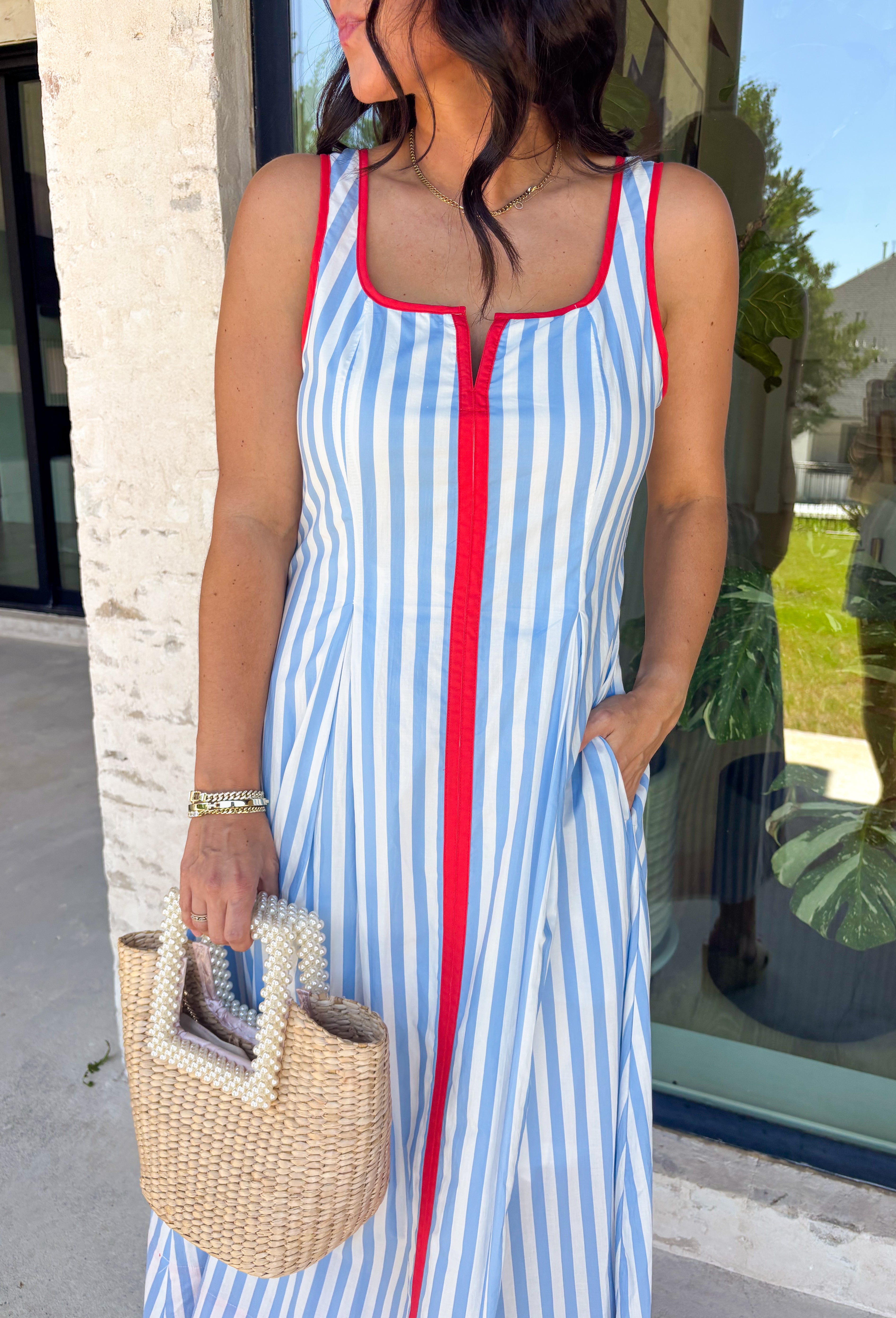 Classic stripes with a pop of color? Yes please! This blue and white striped sleeveless midi dress by Entro is the perfect spring-to-summer piece when you want something easy, flattering, and a little fun. The red contrast trim adds the cutest standout detail, and the v-cut neckline gives it a clean, modern touch that feels effortlessly polished. Just add sandals and sunnies for daytime, or dress it up with wedges and gold jewelry for an easy night-out look.