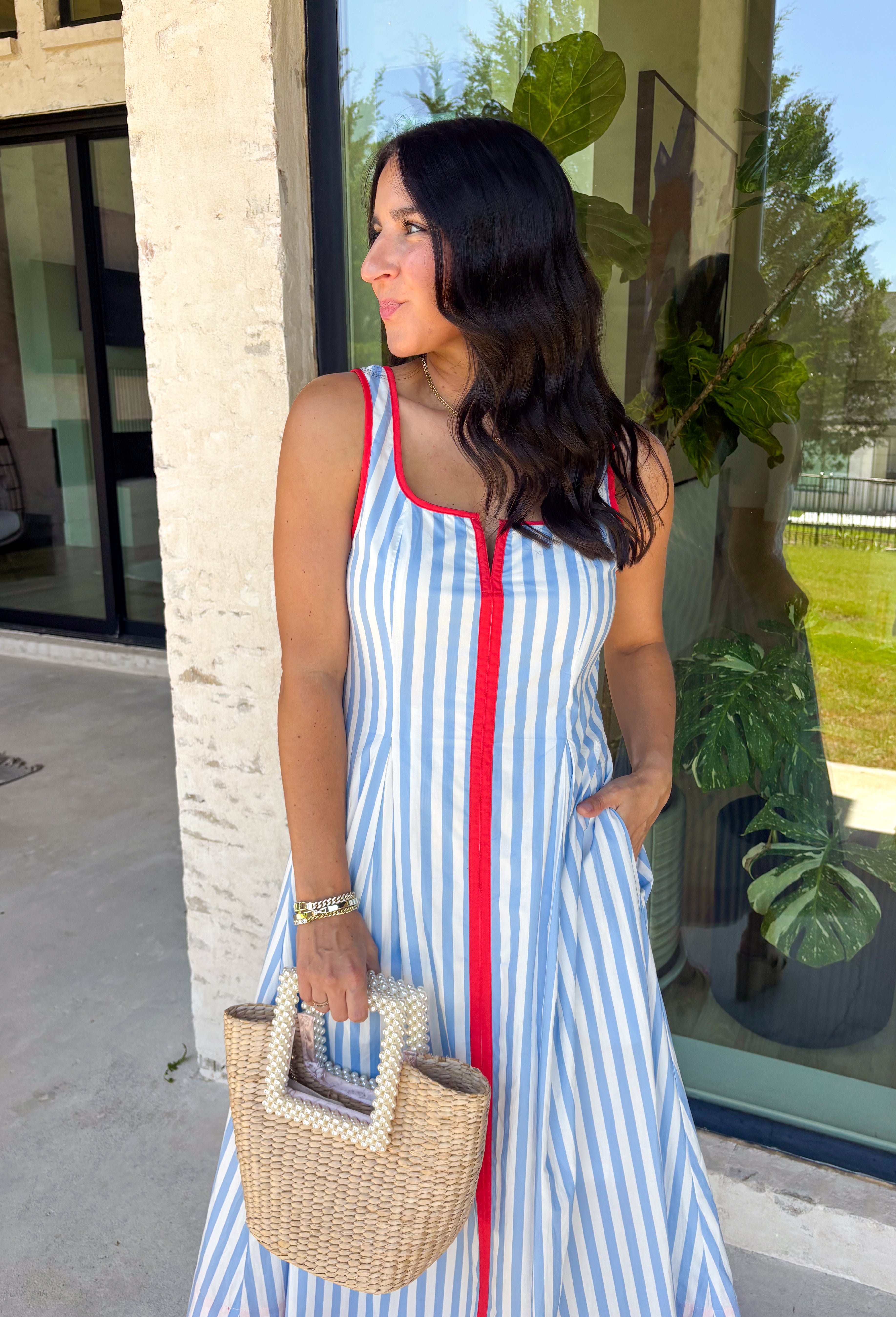 Classic stripes with a pop of color? Yes please! This blue and white striped sleeveless midi dress by Entro is the perfect spring-to-summer piece when you want something easy, flattering, and a little fun. The red contrast trim adds the cutest standout detail, and the v-cut neckline gives it a clean, modern touch that feels effortlessly polished. Just add sandals and sunnies for daytime, or dress it up with wedges and gold jewelry for an easy night-out look.