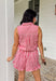 Meet your go-to romper for sunny days and festive celebrations. This red and white striped sleeveless romper is giving effortless summer charm with a playful, patriotic twist—perfect for the 4th of July and beyond. Designed with a collared neckline and front snap button detail, it has a polished feel while still keeping things relaxed and easy. The elastic waist with an adjustable tie creates a flattering, comfortable fit, and the chest pockets plus side pockets add that practical touch