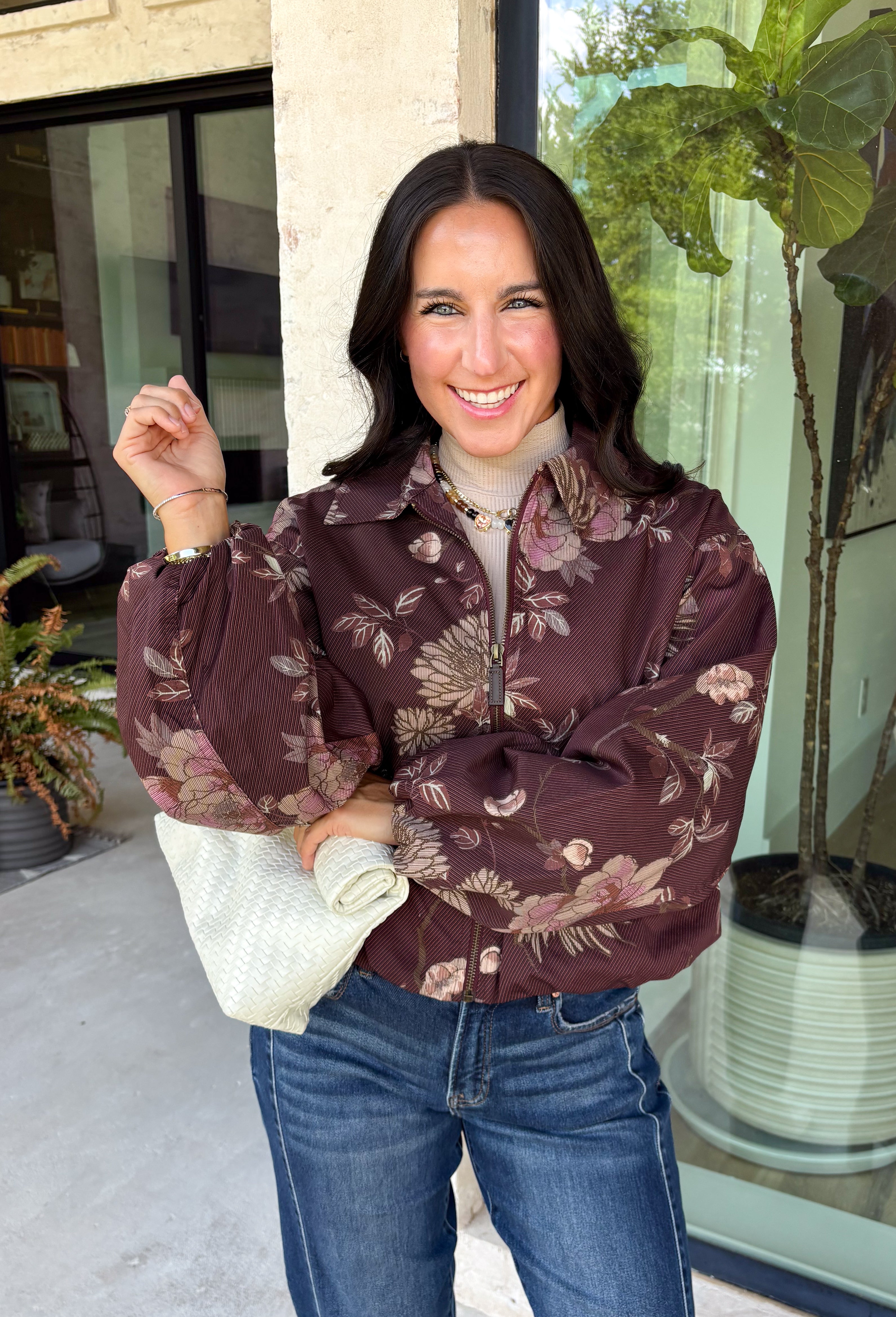Make your fall layers a little more interesting with this deep burgundy jacket from Entro. A unique mix of stripes and neutral floral prints brings together rich autumn shades for a look that stands out while still being easy to style. The collared neckline and zipper-front closure give it a classic jacket feel, while the bubble hem adds shape and a fun, modern finish. Made from 100% cotton, it’s a great lightweight layer for those in-between fall days when you need just a little something extra. 