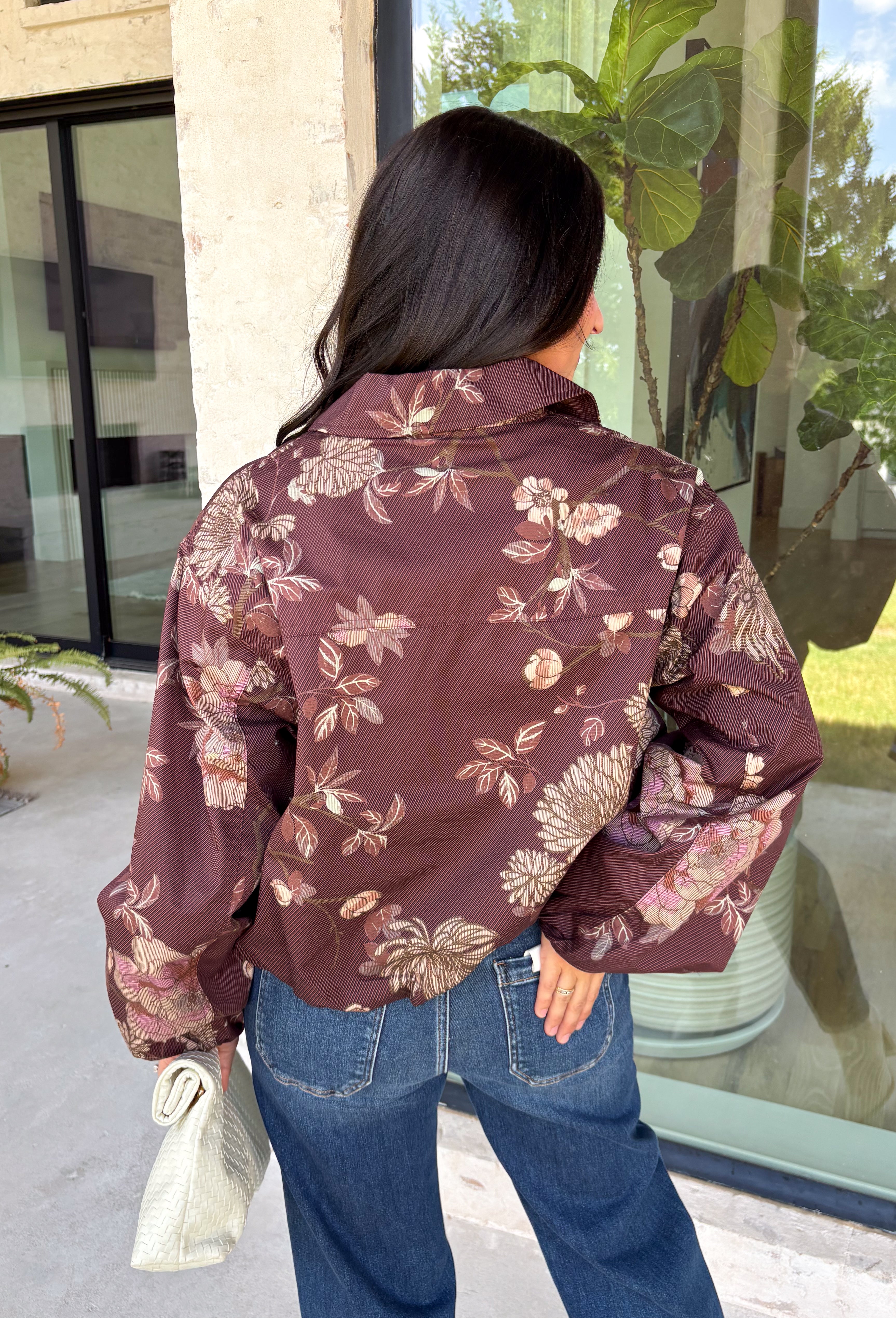 Make your fall layers a little more interesting with this deep burgundy jacket from Entro. A unique mix of stripes and neutral floral prints brings together rich autumn shades for a look that stands out while still being easy to style. The collared neckline and zipper-front closure give it a classic jacket feel, while the bubble hem adds shape and a fun, modern finish. Made from 100% cotton, it’s a great lightweight layer for those in-between fall days when you need just a little something extra. 