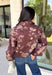 Make your fall layers a little more interesting with this deep burgundy jacket from Entro. A unique mix of stripes and neutral floral prints brings together rich autumn shades for a look that stands out while still being easy to style. The collared neckline and zipper-front closure give it a classic jacket feel, while the bubble hem adds shape and a fun, modern finish. Made from 100% cotton, it’s a great lightweight layer for those in-between fall days when you need just a little something extra. 