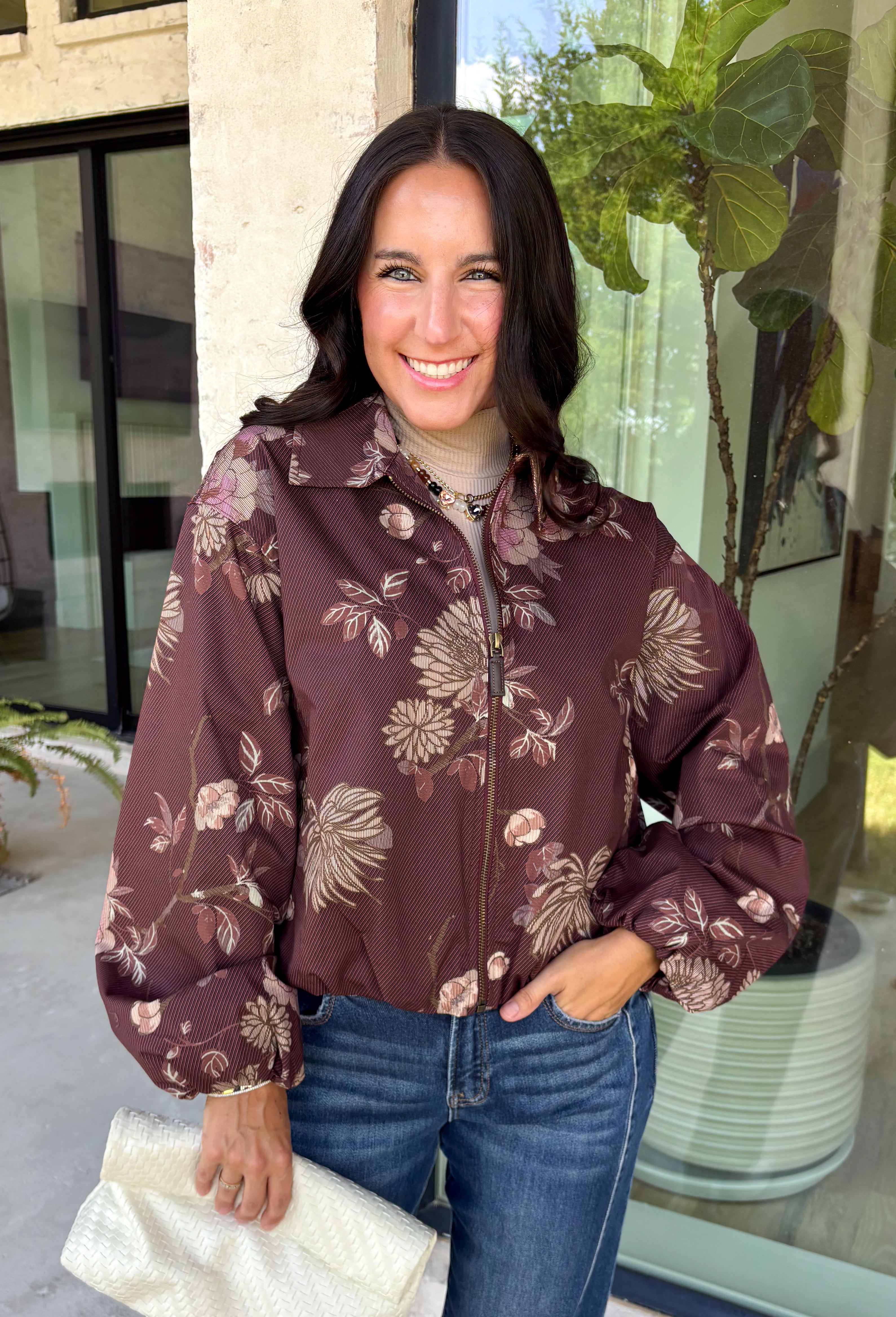 Make your fall layers a little more interesting with this deep burgundy jacket from Entro. A unique mix of stripes and neutral floral prints brings together rich autumn shades for a look that stands out while still being easy to style. The collared neckline and zipper-front closure give it a classic jacket feel, while the bubble hem adds shape and a fun, modern finish. Made from 100% cotton, it’s a great lightweight layer for those in-between fall days when you need just a little something extra. 