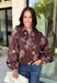 Make your fall layers a little more interesting with this deep burgundy jacket from Entro. A unique mix of stripes and neutral floral prints brings together rich autumn shades for a look that stands out while still being easy to style. The collared neckline and zipper-front closure give it a classic jacket feel, while the bubble hem adds shape and a fun, modern finish. Made from 100% cotton, it’s a great lightweight layer for those in-between fall days when you need just a little something extra. 