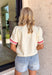 This off white short sleeve top is the perfect mix of classic and fun for summer! The clean, neutral base keeps it easy to style, while the red stripe detail on the sleeves adds that sporty pop of color. The front button detail gives it a polished, elevated touch, and the ruffle cuffs bring just the right amount of feminine flair. Lightweight with a soft stretch, it’s comfortable enough for all-day wear—whether you're running errands or meeting up with friends. 