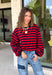 Classic stripes never go out of style, and this cozy knit top from Hyfve is the perfect addition to your fall wardrobe. Featuring bold red and navy stripes, this timeless top offers a relaxed silhouette that's easy to dress up or down. Ribbed detailing at the neckline, cuffs, and hem gives it a polished finish, while the soft fabric keeps you warm and comfortable all day long. 