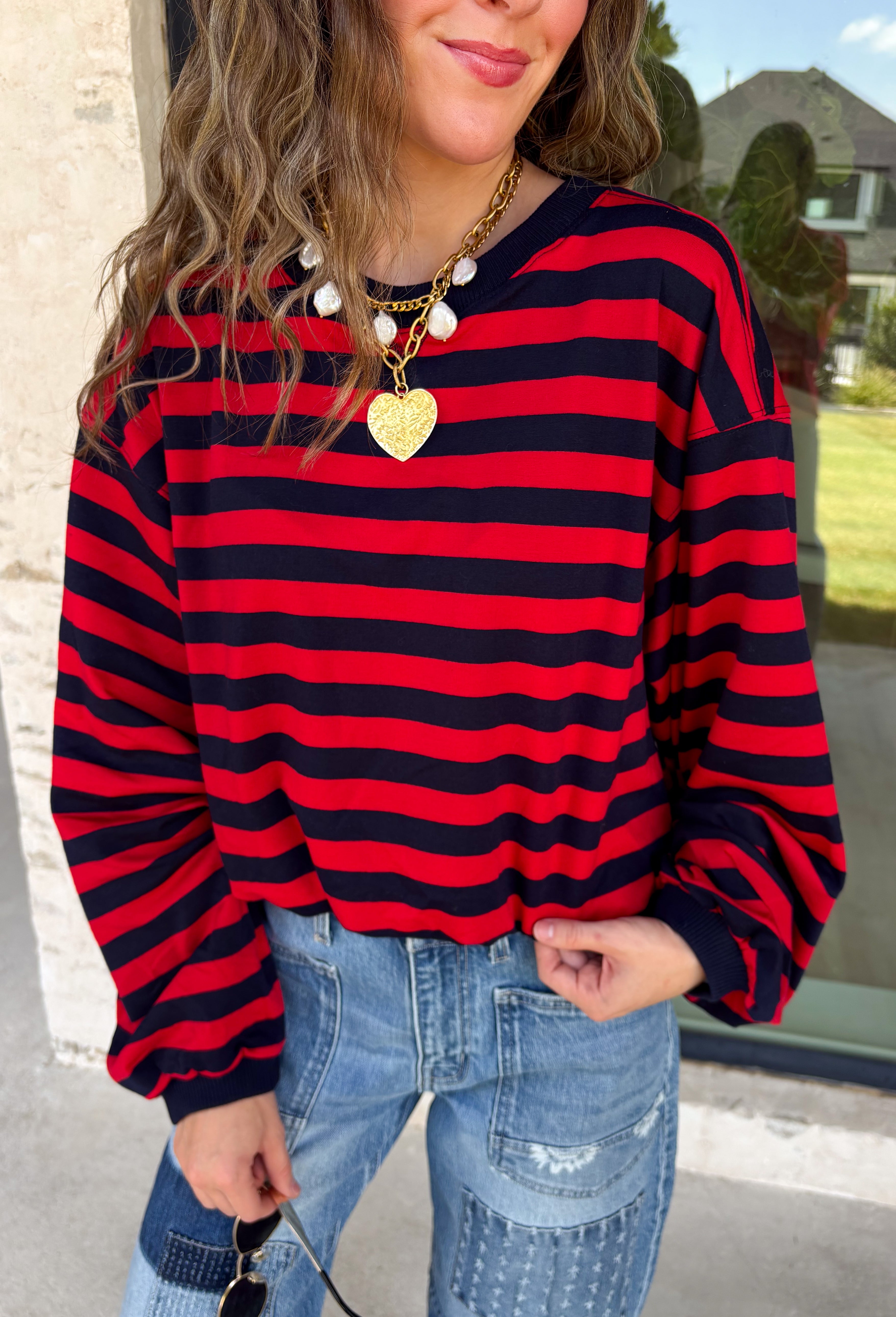 Classic stripes never go out of style, and this cozy knit top from Hyfve is the perfect addition to your fall wardrobe. Featuring bold red and navy stripes, this timeless top offers a relaxed silhouette that's easy to dress up or down. Ribbed detailing at the neckline, cuffs, and hem gives it a polished finish, while the soft fabric keeps you warm and comfortable all day long. 