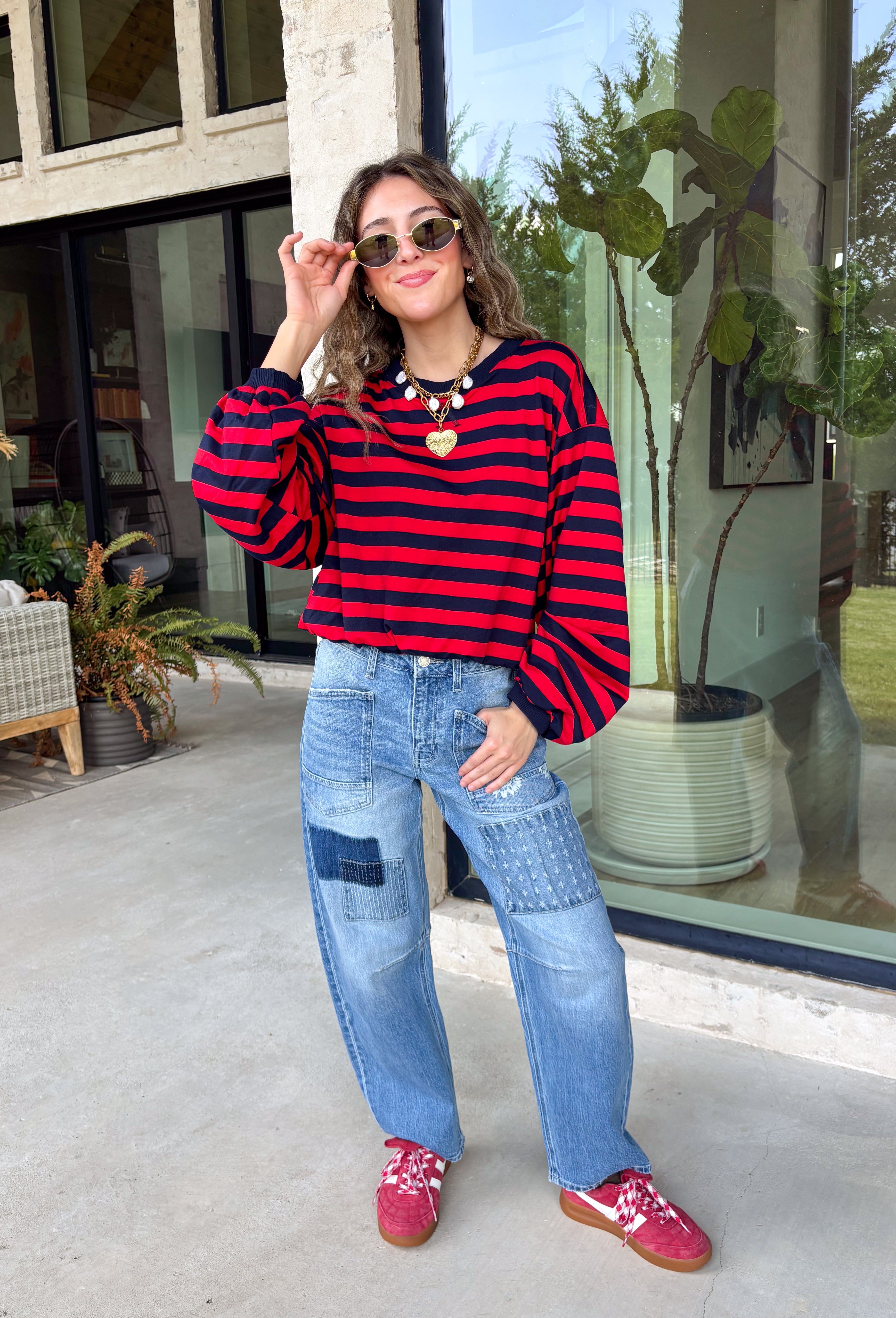 Classic stripes never go out of style, and this cozy knit top from Hyfve is the perfect addition to your fall wardrobe. Featuring bold red and navy stripes, this timeless top offers a relaxed silhouette that's easy to dress up or down. Ribbed detailing at the neckline, cuffs, and hem gives it a polished finish, while the soft fabric keeps you warm and comfortable all day long. 