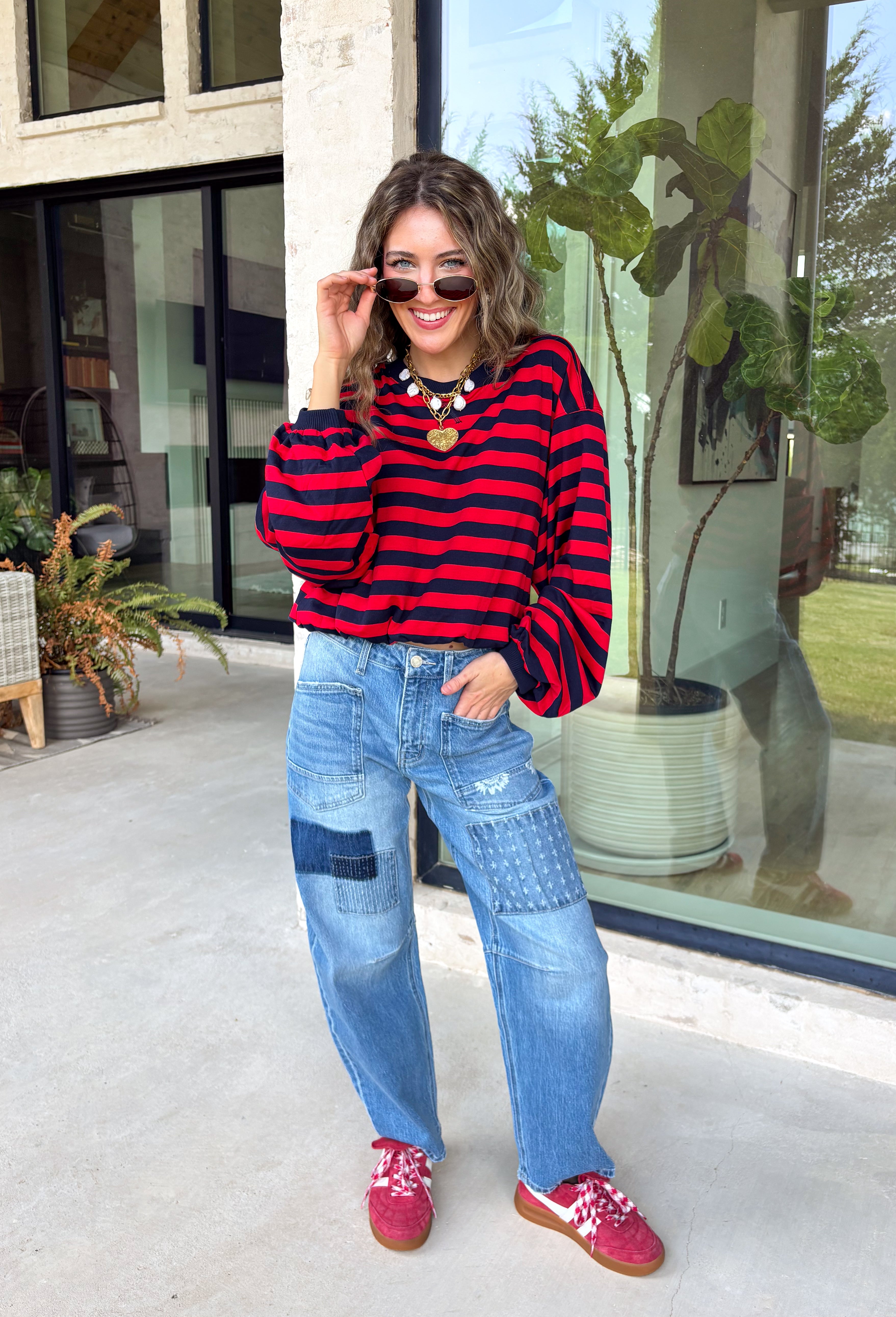 Classic stripes never go out of style, and this cozy knit top from Hyfve is the perfect addition to your fall wardrobe. Featuring bold red and navy stripes, this timeless top offers a relaxed silhouette that's easy to dress up or down. Ribbed detailing at the neckline, cuffs, and hem gives it a polished finish, while the soft fabric keeps you warm and comfortable all day long. 