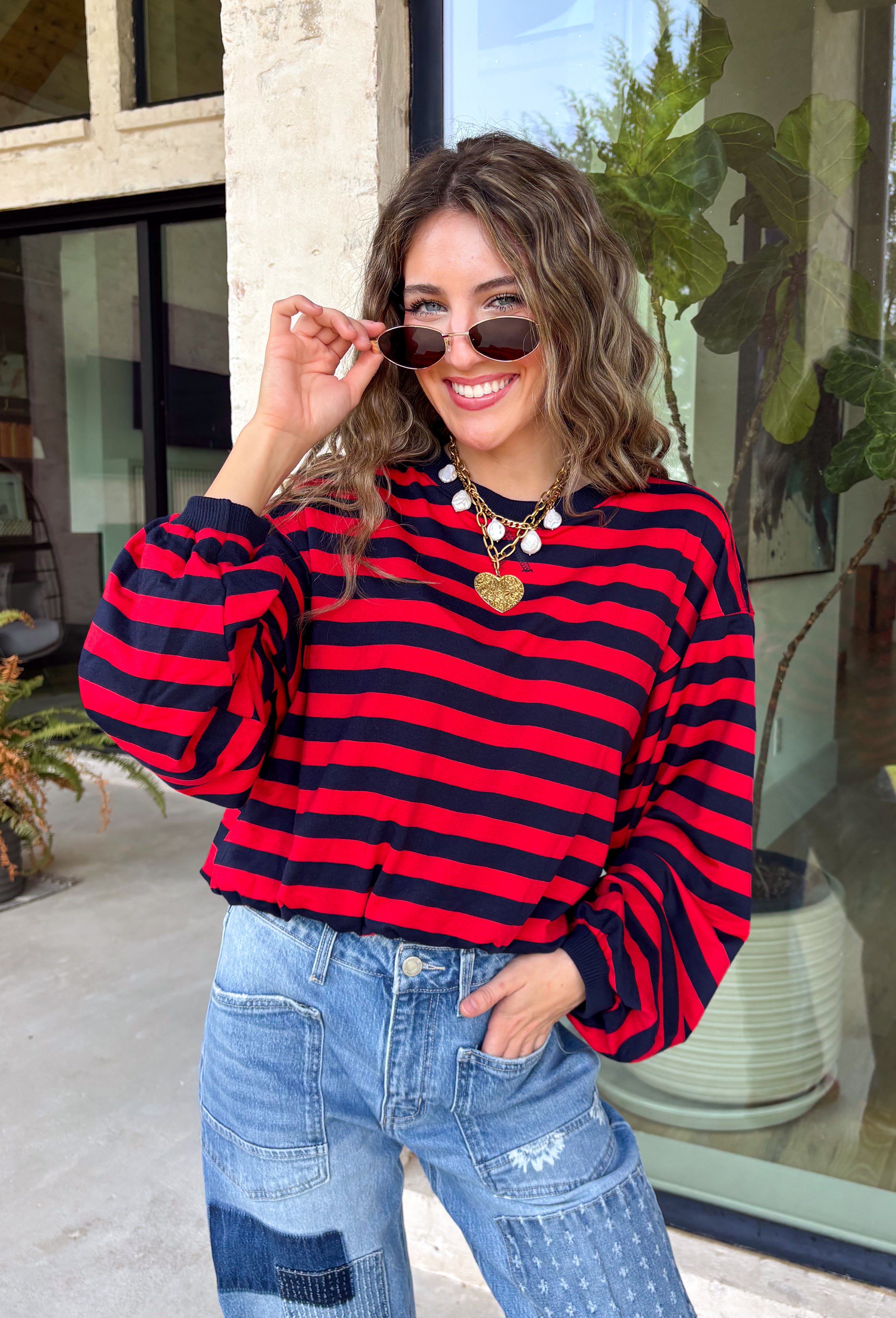 Classic stripes never go out of style, and this cozy knit top from Hyfve is the perfect addition to your fall wardrobe. Featuring bold red and navy stripes, this timeless top offers a relaxed silhouette that's easy to dress up or down. Ribbed detailing at the neckline, cuffs, and hem gives it a polished finish, while the soft fabric keeps you warm and comfortable all day long. 